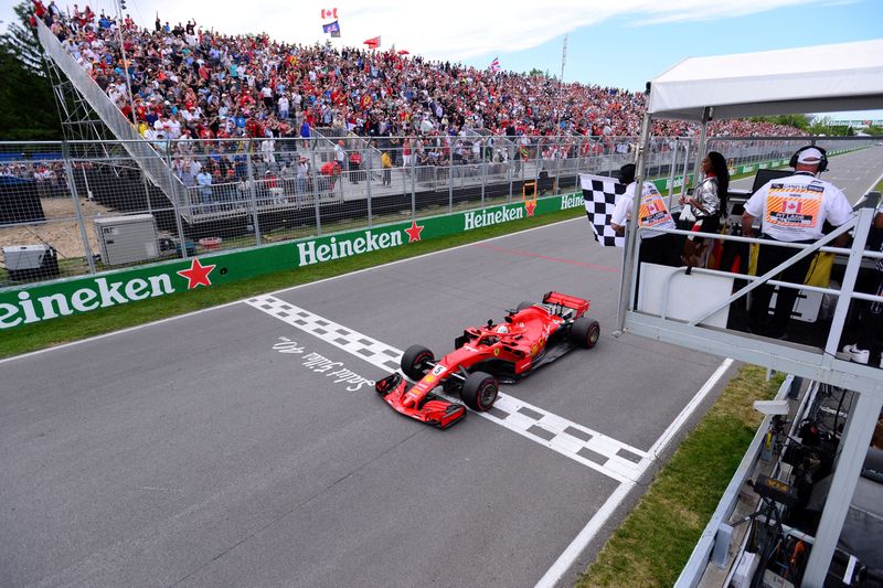 FILE PHOTO: Formula One F1 - Canadian Grand Prix - Circuit Gilles Villeneuve, Montreal, Canada - June 10, 2018   Ferrari's Sebastian Vettel passes the chequered flag to win the race   Paul Chiasson/Pool via REUTERS
