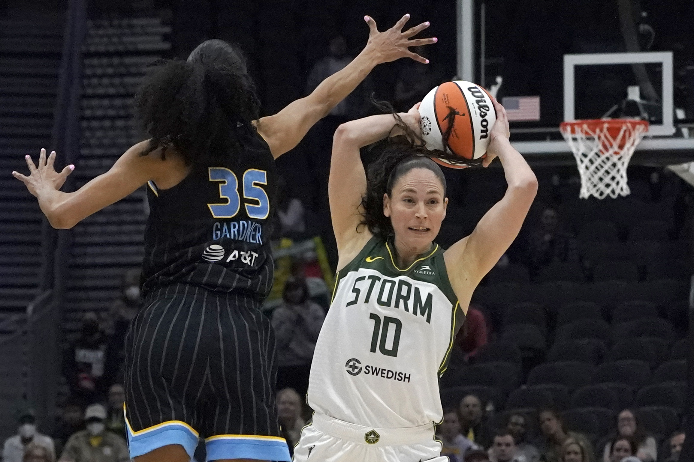 Seattle Storm guard Sue Bird (10) passes around the defense of Chicago Sky guard Rebekah Gardner (35) during the second half of a WNBA basketball game Wednesday, May 18, 2022, in Seattle. The Storm won 74-71.