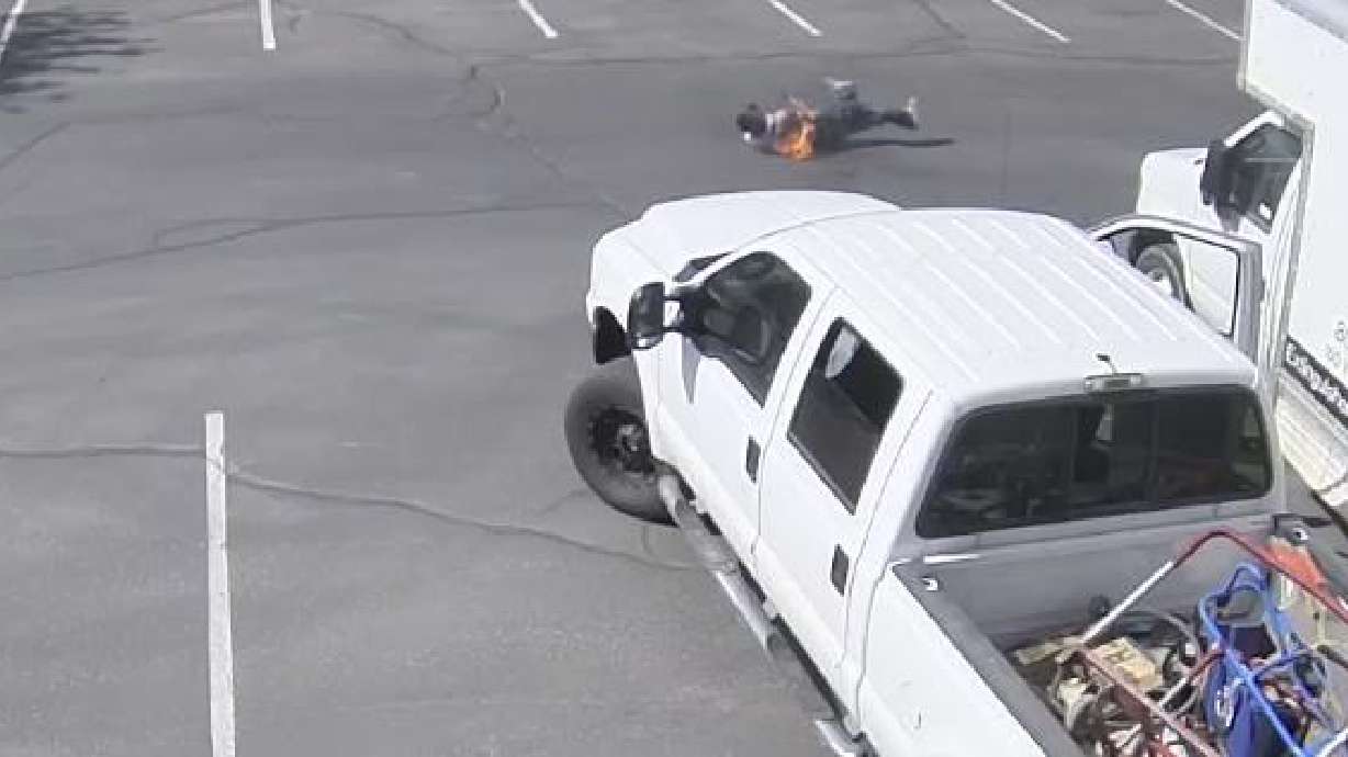 An unidentified man catches fire and rolls to try and extinguish it after Summit Fire and Protection employees say he drilled into the gas tank of a truck in their parking lot on Saturday. Another man was arrested last month after drilling a hole into the gas tanks of at least three vehicles in West Jordan to siphon the gas, police say.