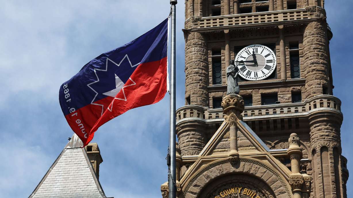 The Juneteenth flag flies at the Salt Lake City-County Building on Tuesday. While much of the state will observe the holiday, many school districts do not have the holiday on their calendars this year.