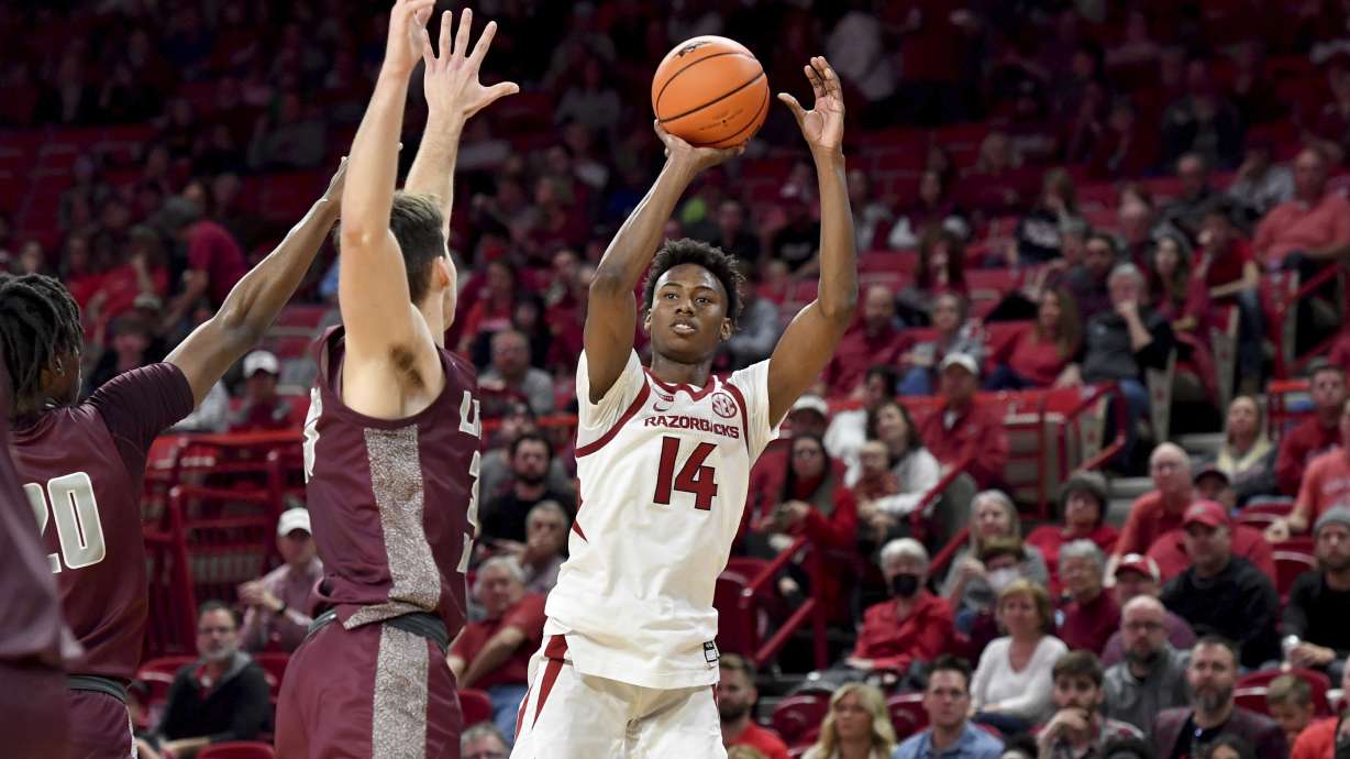 Arkansas guard Jaxson Robinson (14) shoots over an Arkansas-Little Rock defender during the first half of an NCAA college basketball game Saturday, Dec. 4, 2021, in Fayetteville, Ark.