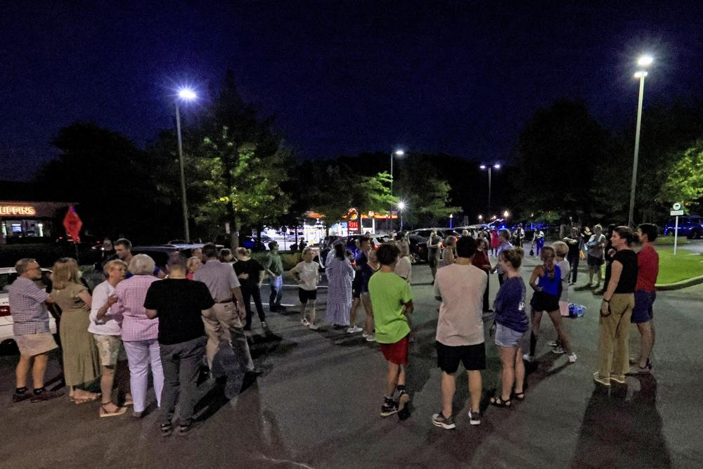 Church members gather for a prayer circle after a shooting at the Saint Stevens Episcopal Church on Thursday in Vestavia, Ala. A lone suspect fired on a small group meeting at a suburban church near one of Alabama’s major cities Thursday evening, fatally wounding two people and injuring a third before being taken into custody, authorities said.