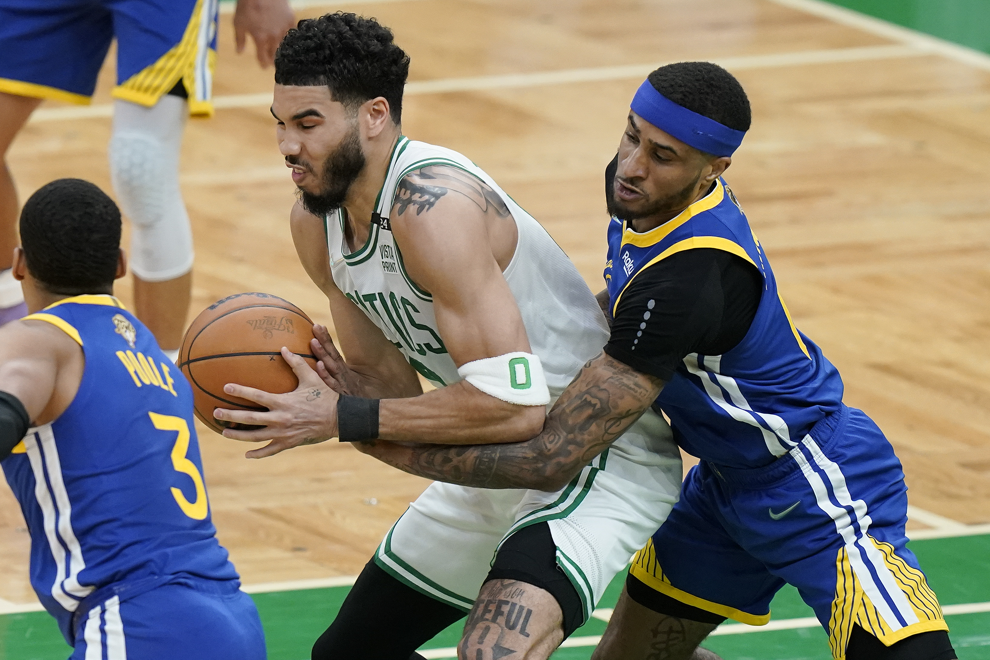 Golden State Warriors guard Gary Payton II (0) tries to strip the ball from Boston Celtics forward Jayson Tatum (0) during the first quarter of Game 6 of basketball's NBA Finals, Thursday, June 16, 2022, in Boston.