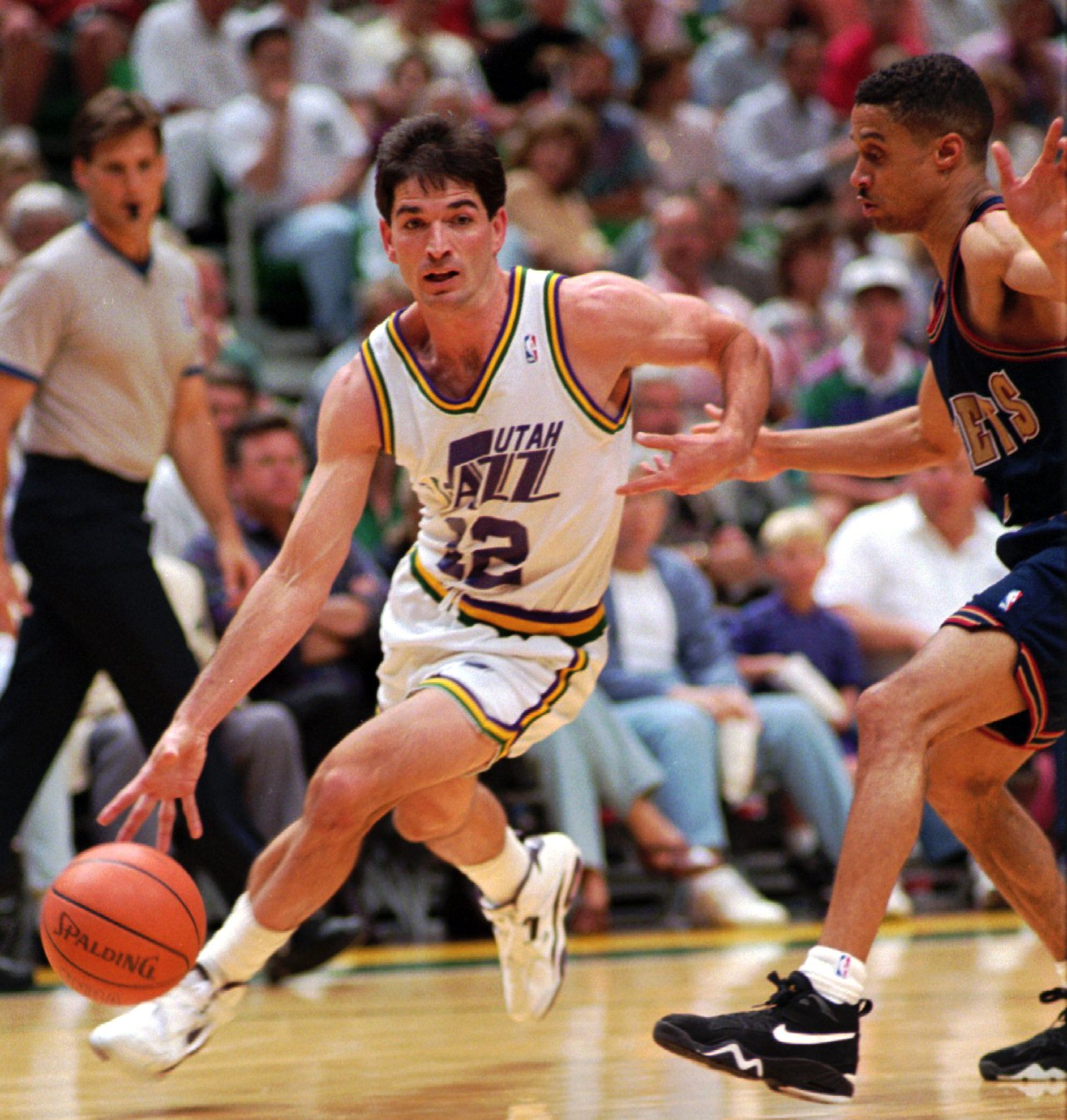 Utah Jazz guard John Stockton drives around Denver Nugget Mahmoud Abdul-Rauf during 2nd half action in the first game of their playoff game in 1994.