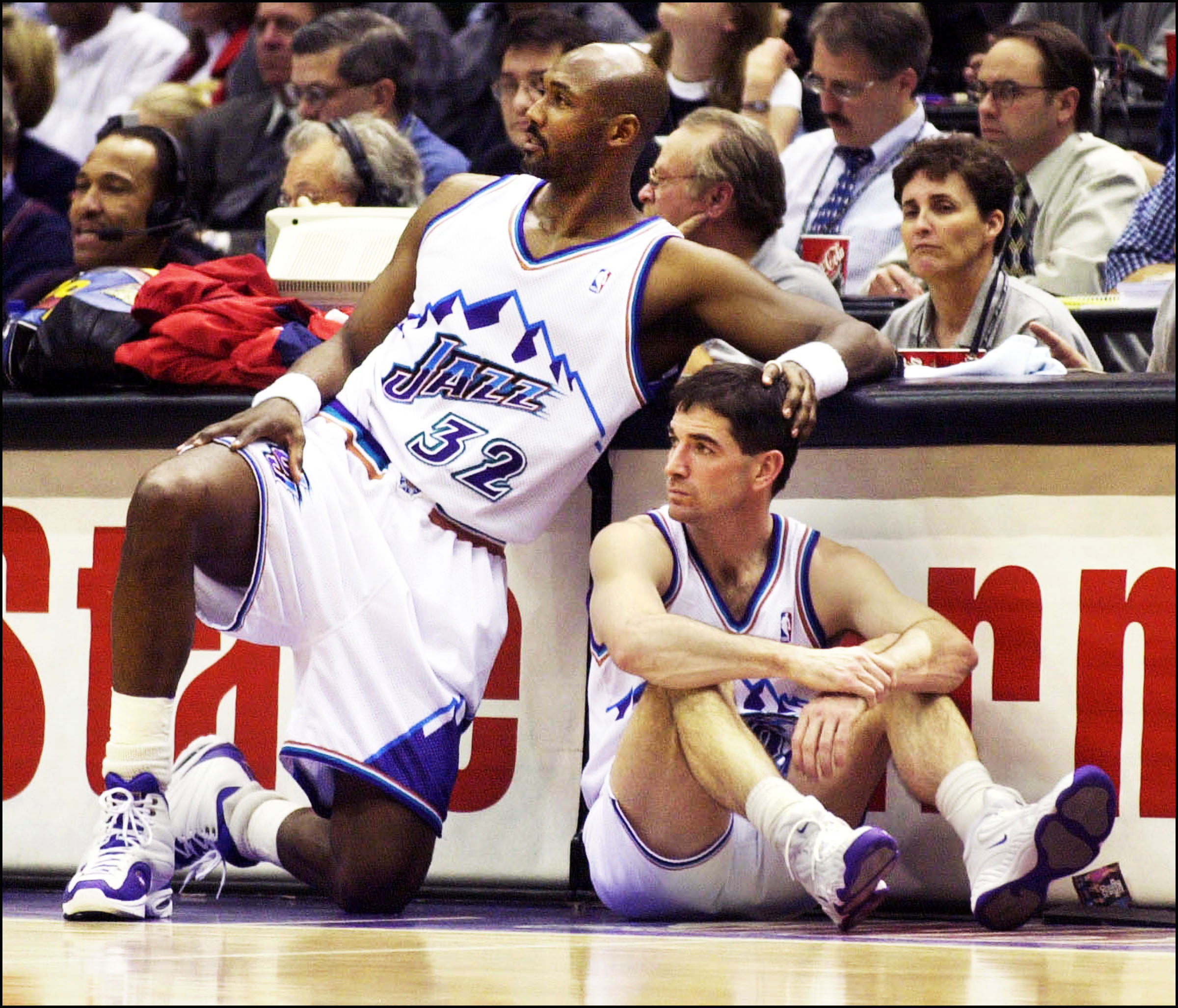 Karl Malone gives John Stockton a touch on the head as they wait to go into the game against the Charlotte Hornets in Salt Lake City on Feb. 1, 2001.
