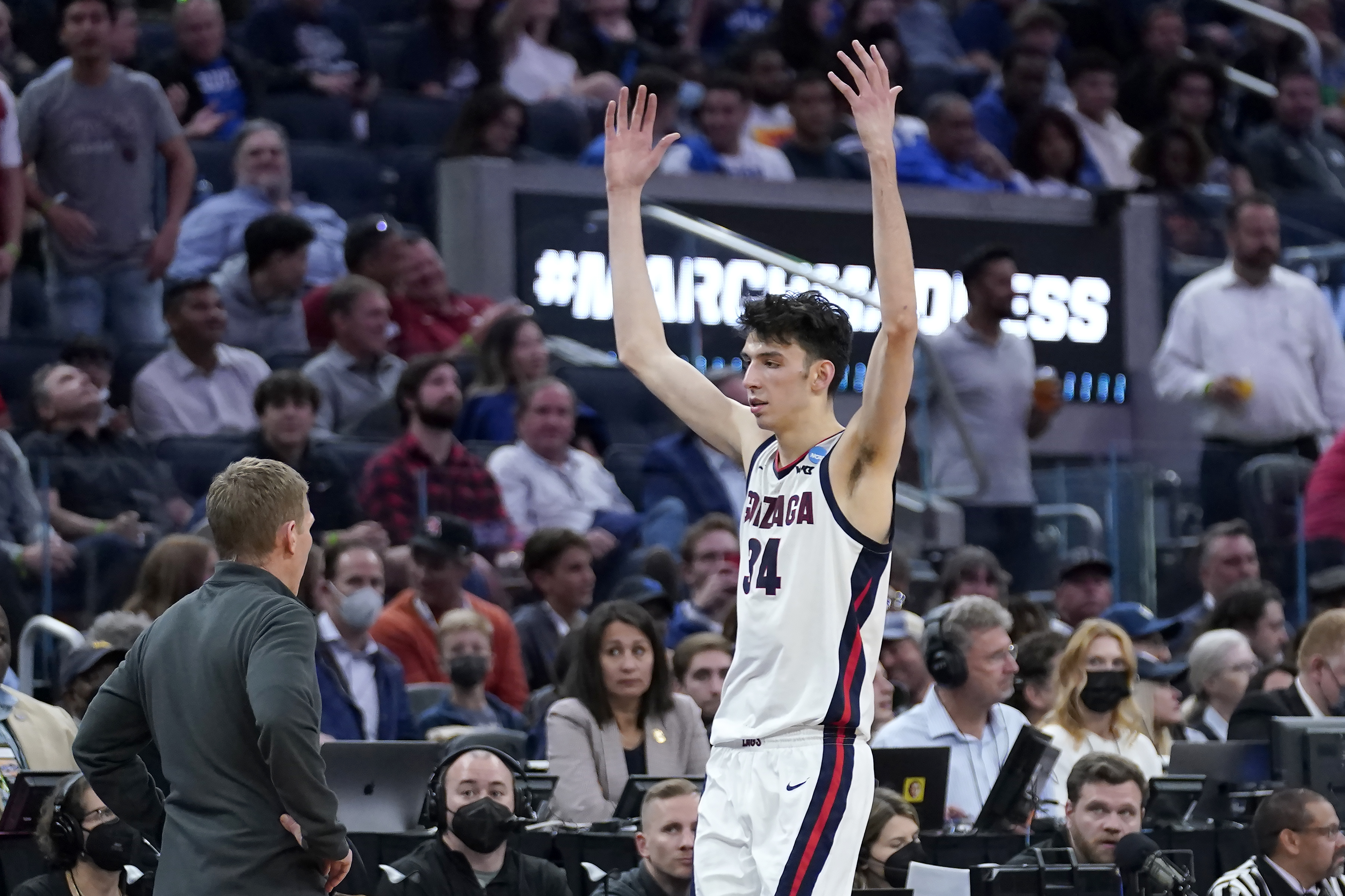 FILE - Gonzaga center Chet Holmgren (34) reacts as he walks to the bench after fouling out next to head coach Mark Few during the second half of a college basketball game against Arkansas in the Sweet 16 round of the NCAA tournament in San Francisco, Thursday, March 24, 2022. Gonzaga’s Chet Holmgren was wrapping up a multi-day visit Friday with the Orlando Magic, who hold the No. 1 pick in next week’s NBA draft. 