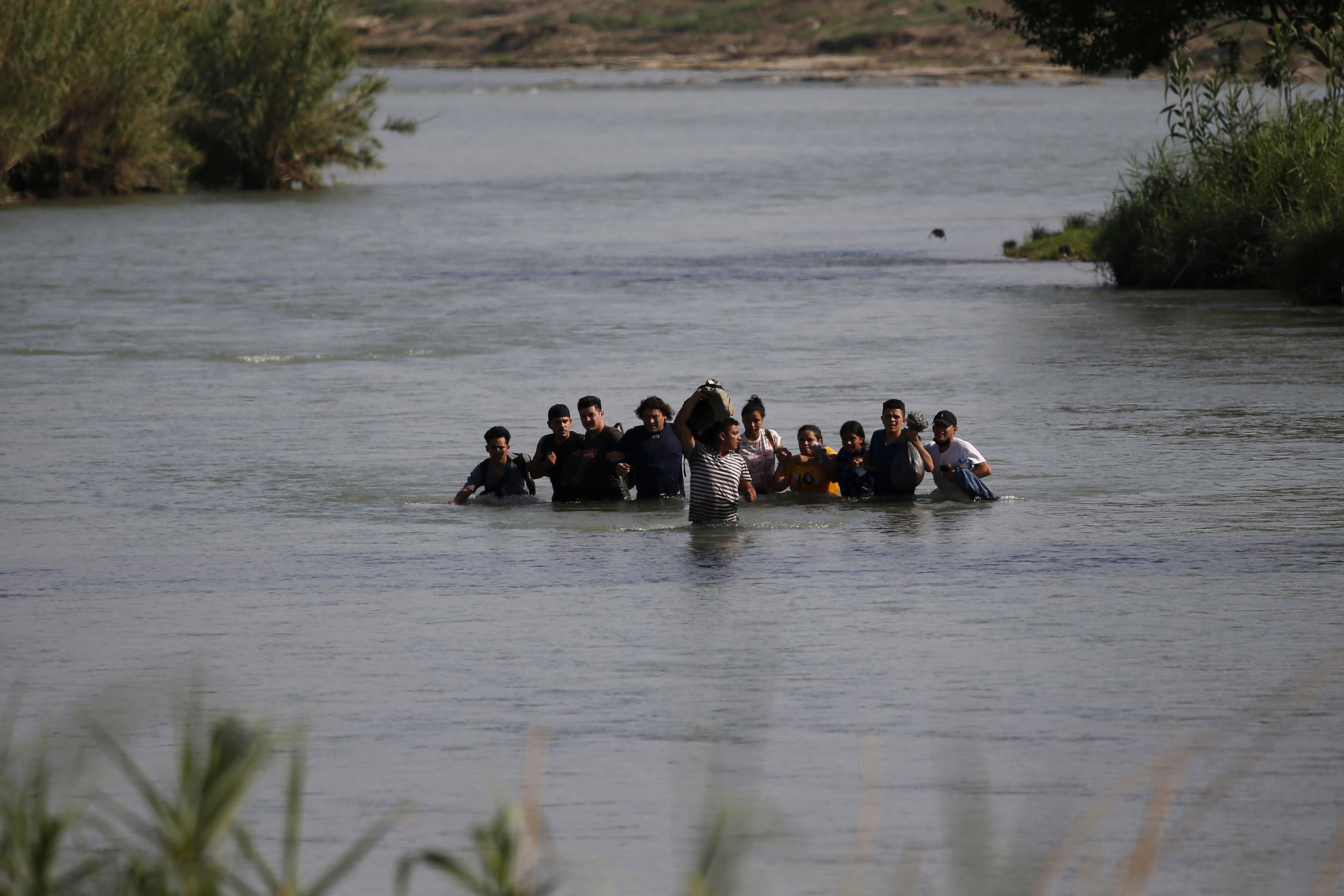 Migrants, mostly from Nicaragua, cross the Rio Grande river into the U.S., at Eagle Pass, Texas on May 20. Officers made more immigration arrests along the U.S.-Mexico border in May than any month since records were kept.
