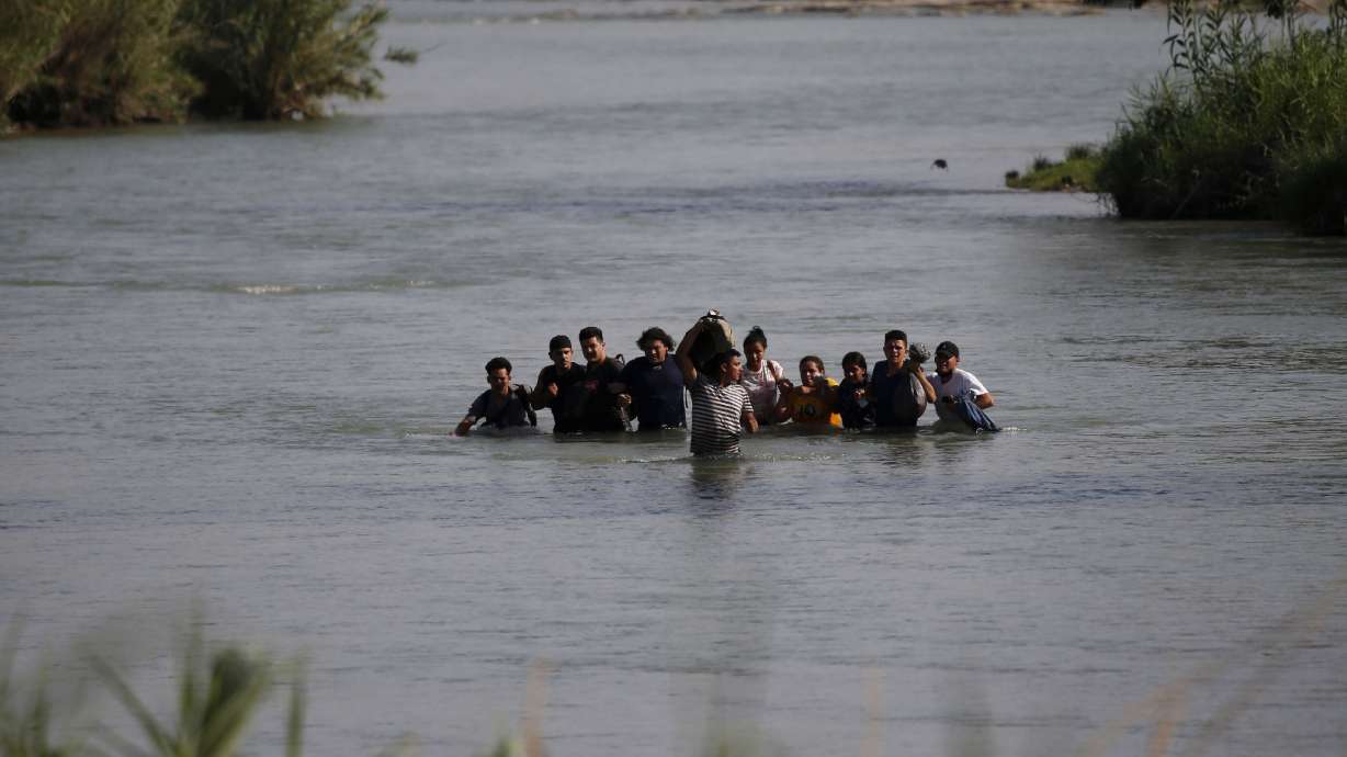 Migrants, mostly from Nicaragua, cross the Rio Grande river into the U.S., at Eagle Pass, Texas on May 20. Officers made more immigration arrests along the U.S.-Mexico border in May than any month since records were kept.