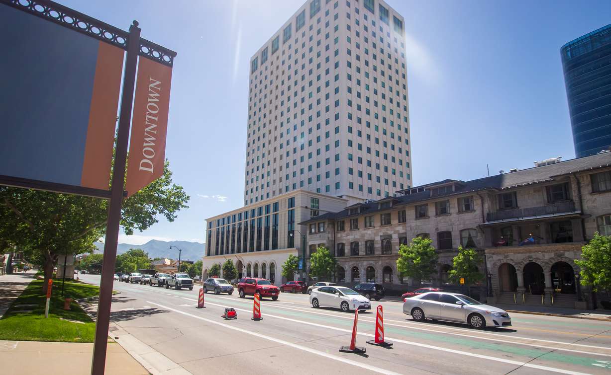Vehicles travel past the South Temple Tower in downtown Salt Lake City on June 18, 2022. Window spaces on the building's north and south ends were ended, which is one of the more noticeable changes of the building's renovation into housing.
