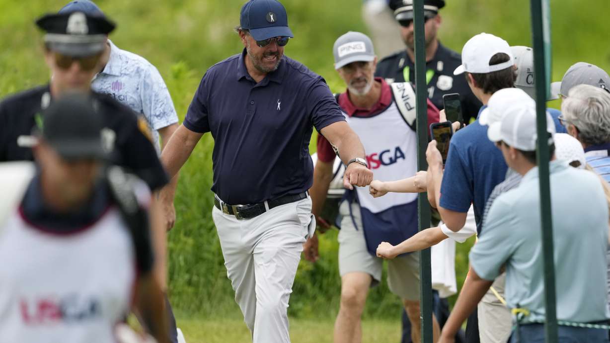 Phil Mickelson greets fans during the second round of the U.S. Open golf tournament at The Country Club, Friday, June 17, 2022, in Brookline, Mass.