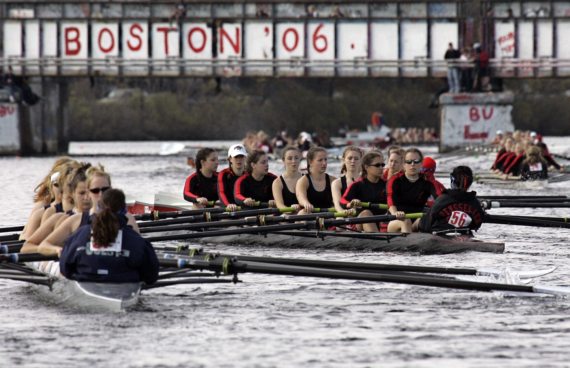 FILE - Competitors head to the starting line for Collegiate Women's Eights during the Head of the Charles Regatta in Cambridge, Mass., Sunday, Oct. 22, 2006. This month marks the 50th anniversary of the Title IX law that requires equitable treatment of men and women in educational programs that receive federal assistance. 