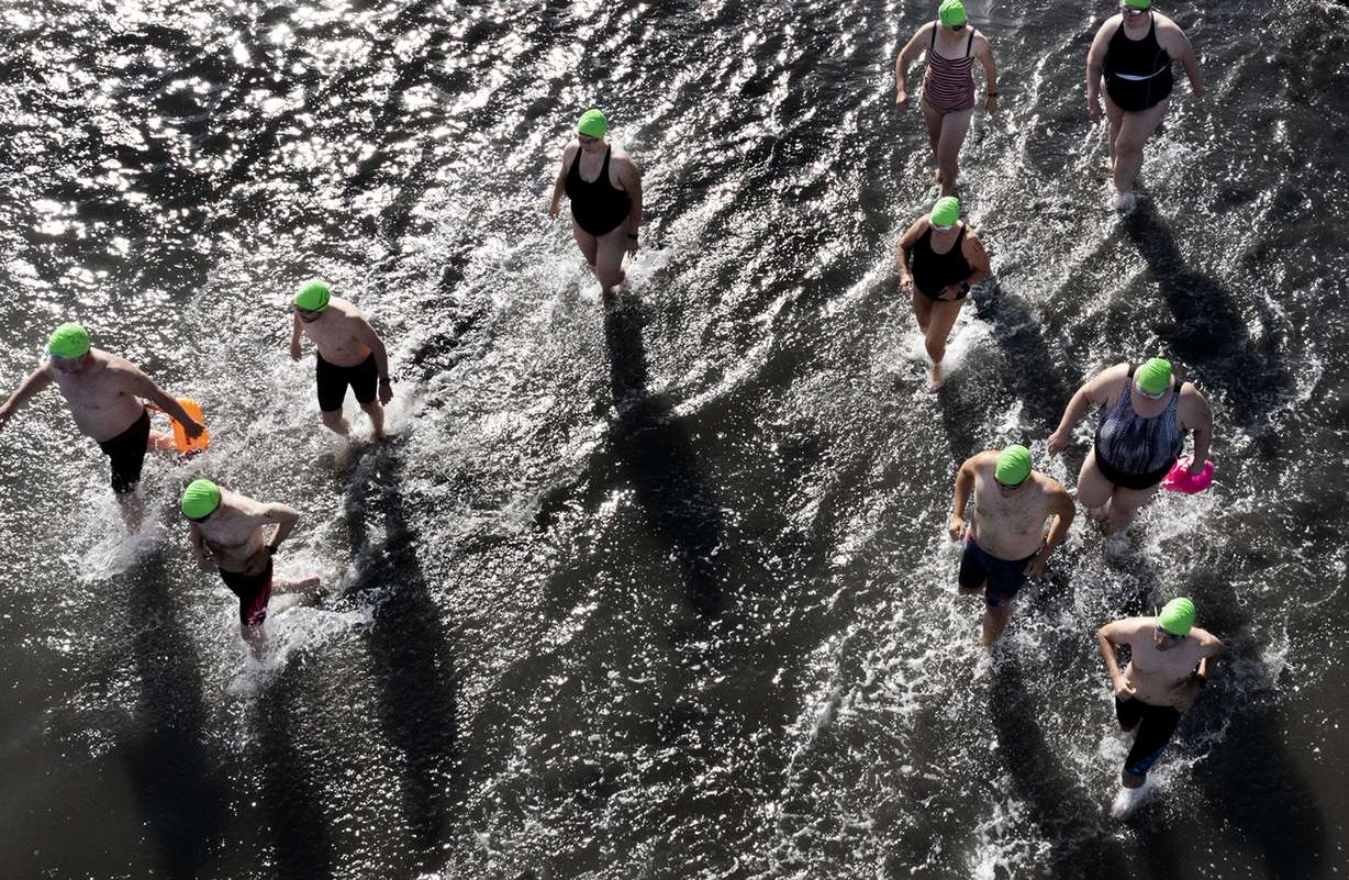 Swimmers run to deeper water during the 1-mile open swim competition at Great Salt Lake State Park in Magna on June 11. Intrepid water enthusiasts took to the dwindling waters of the Great Salt Lake last weekend for the annual open swim.