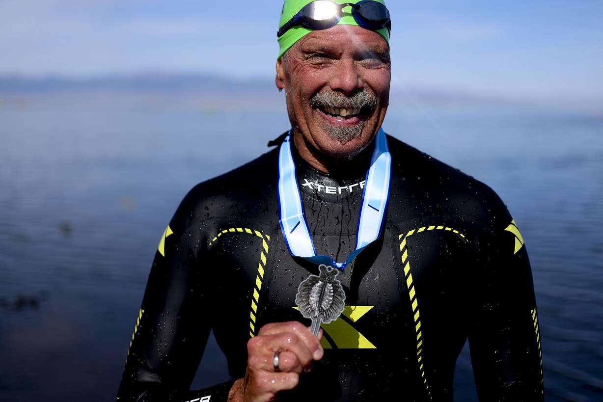 Ted Taylor, of Pleasant Grove, smiles after competing in the 1-mile open swim competition at the Great Salt Lake State Park in Magna on Saturday. This was Taylor’s third time competing in the race. An Orem fire department chaplain and teacher at Cedar Valley High School, Taylor competes in the race to set an example for his students. Three of them competed with Taylor last year; he beat all three of them.