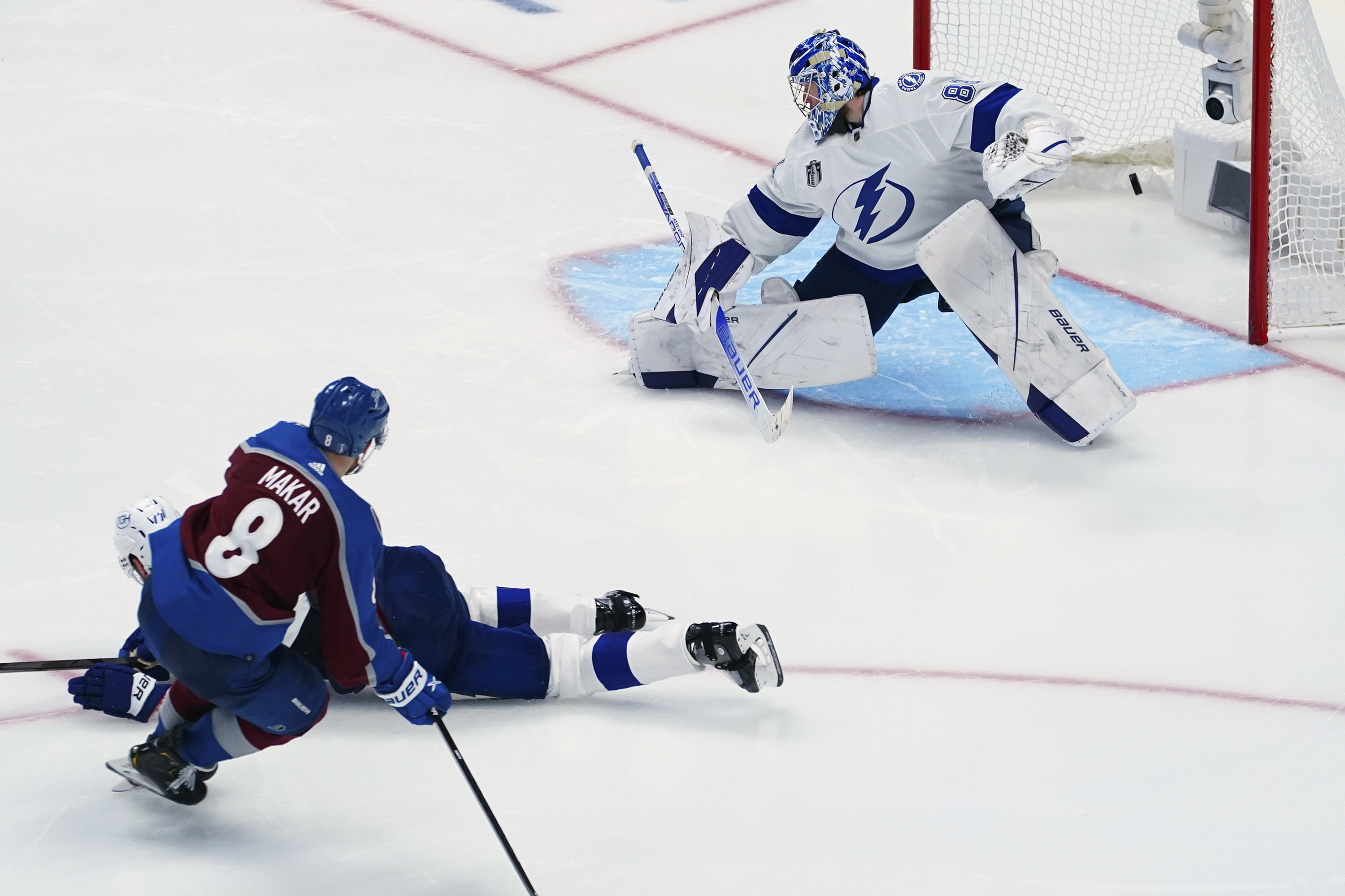 Colorado Avalanche defenseman Cale Makar (8) scores on Tampa Bay Lightning goaltender Andrei Vasilevskiy (88) during the third period in Game 2 of the NHL hockey Stanley Cup Final, Saturday, June 18, 2022, in Denver. 