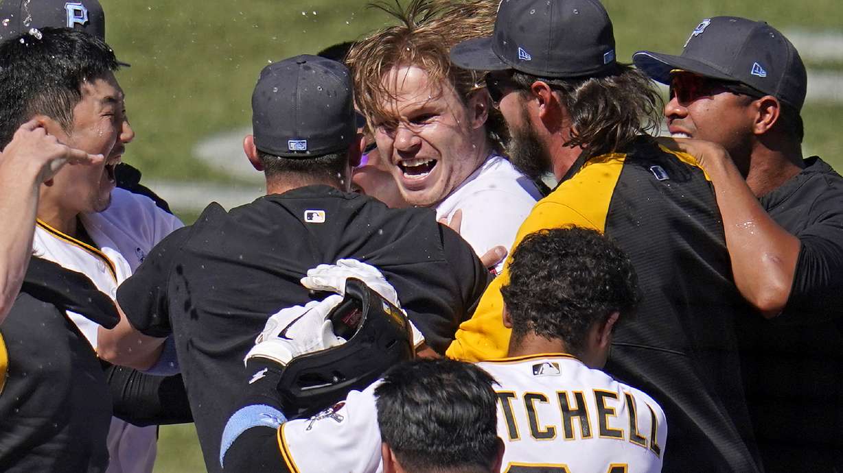 Pittsburgh Pirates' Jack Suwinski, center, is swarmed by teammates after hitting a walkoff solo home run off San Francisco Giants relief pitcher Tyler Rogers during the ninth inning of a baseball game in Pittsburgh, Sunday, June 19, 2022. It was Suwinski's third solo home run of the game.