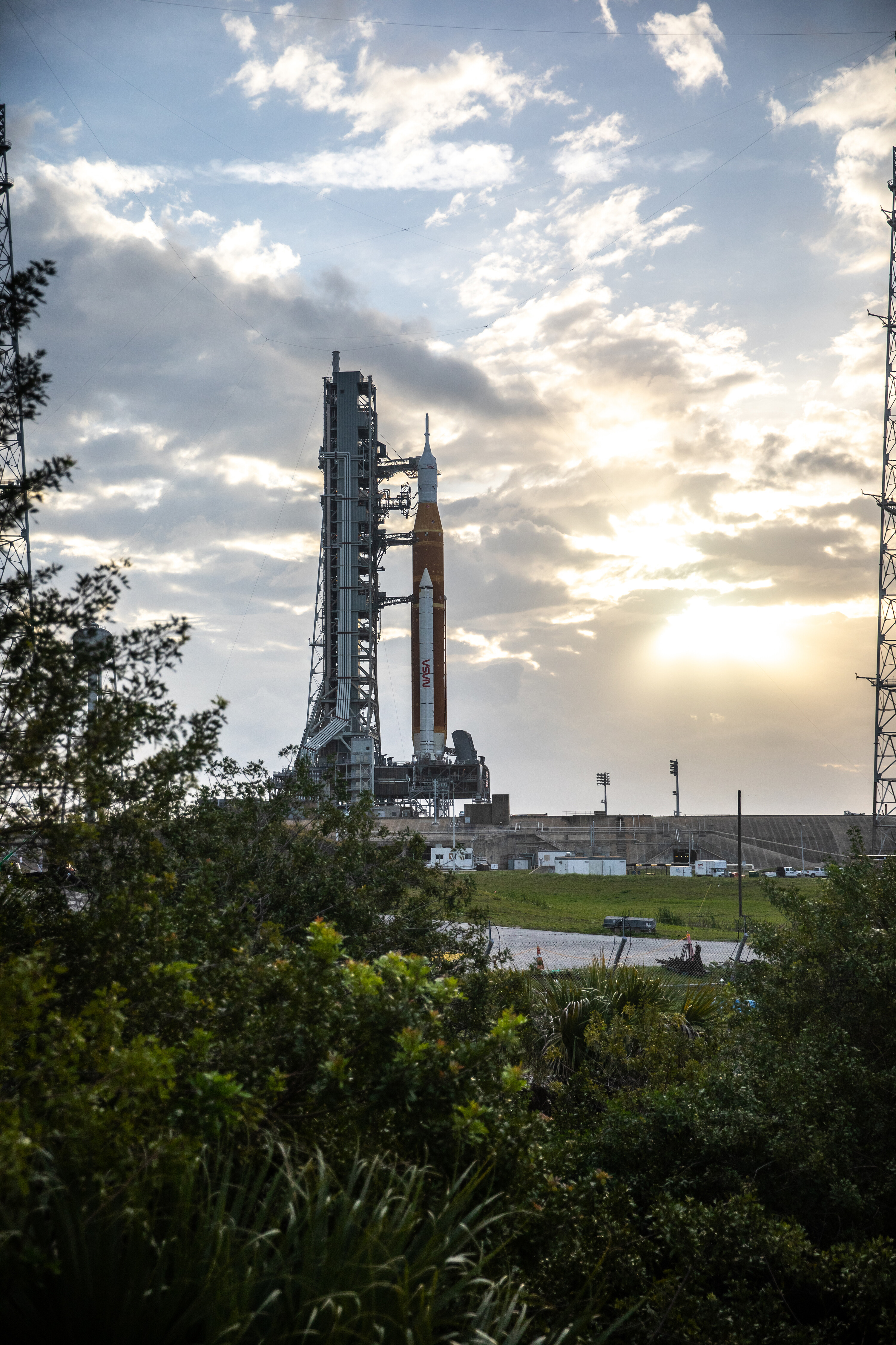 Blue sky and clouds serve as the backdrop for a sunrise view of the Artemis I Space Launch System and Orion spacecraft at Launch Pad 39B at NASA's Kennedy Space Center in Florida on March 23. Monday, the rocket tanks were fully fueled for the first time.