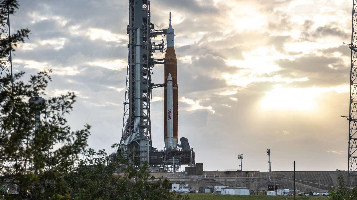 Blue sky and clouds serve as the backdrop for a sunrise view of the Artemis I Space Launch System and Orion spacecraft at Launch Pad 39B at NASA's Kennedy Space Center in Florida on March 23. Monday, the rocket tanks were fully fueled for the first time.