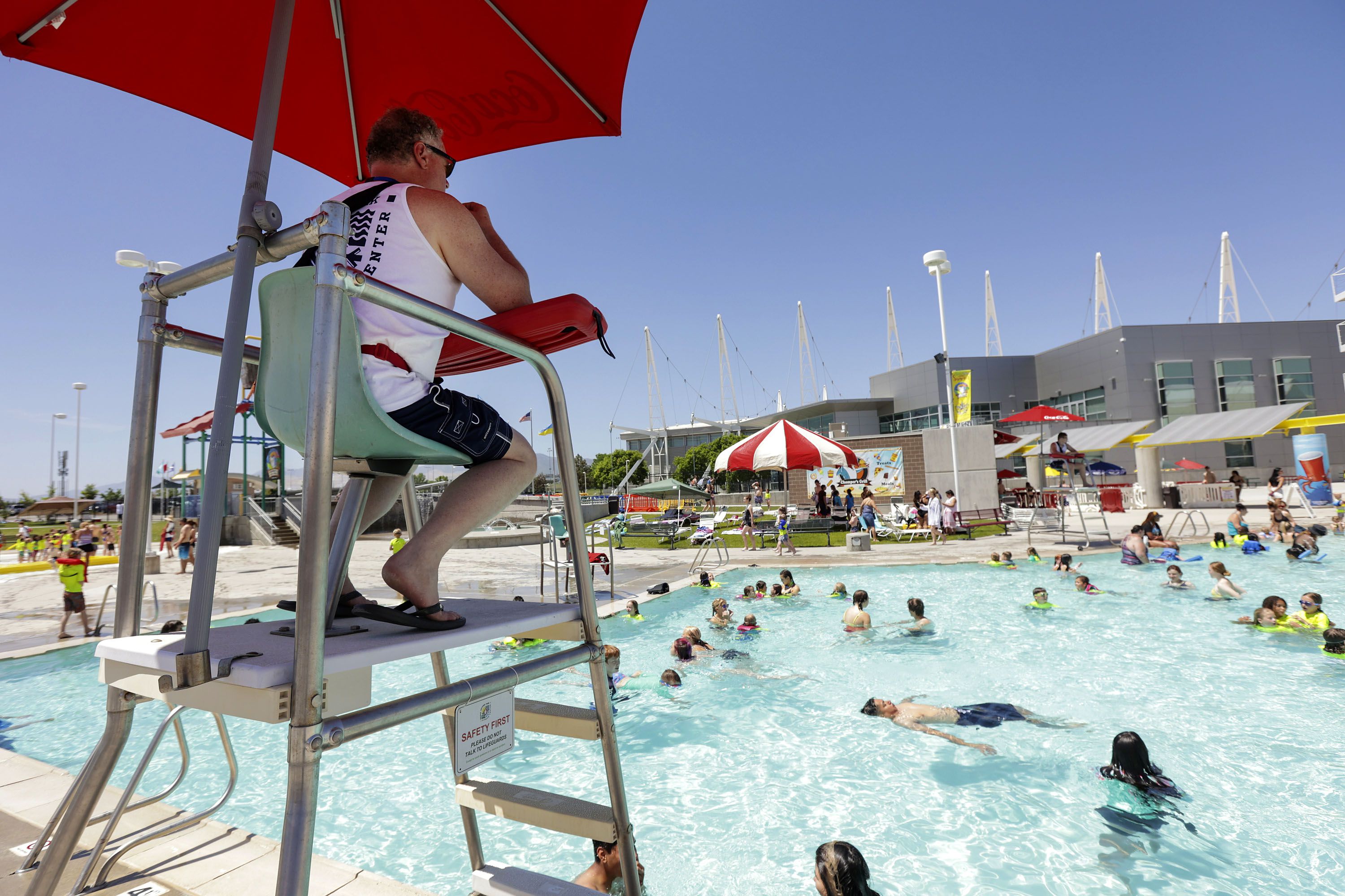 Lifeguard Mark Black watches swimmers at the Kearns Oquirrh Park Fitness Center pool in Kearns on June 10. Some pools have had to limit availability due to staff shortages.
