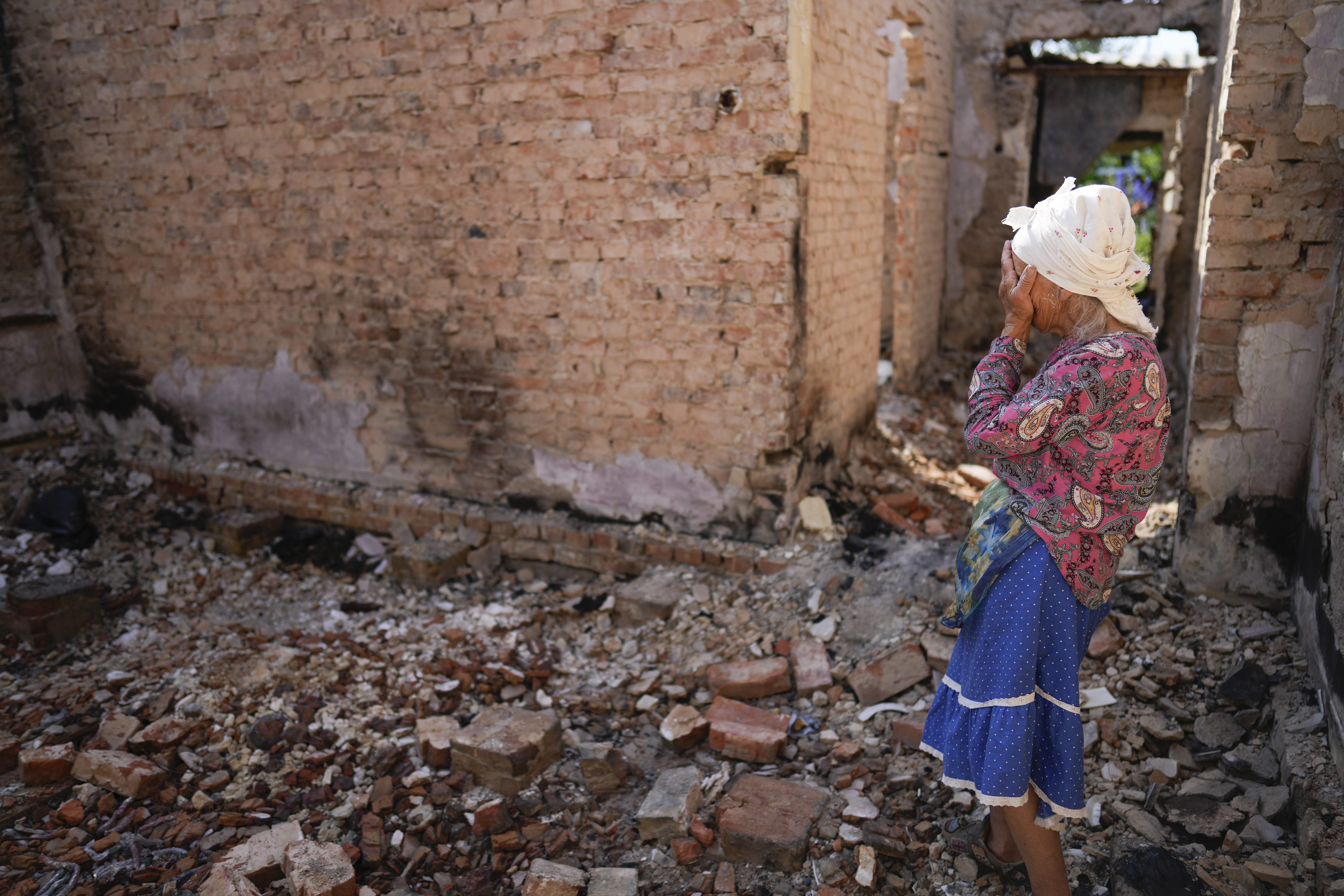 Hanna Sylivon, 76, stands inside her house destroyed by attacks in Chernihiv, Ukraine, Sunday.
