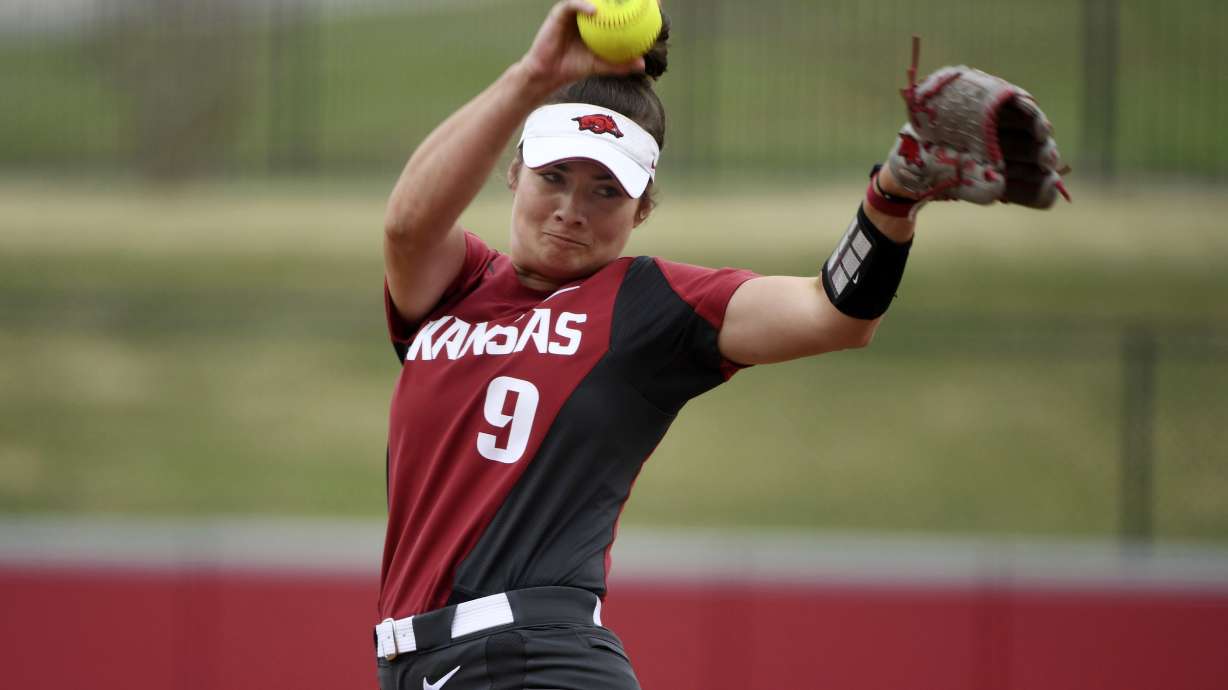 FILE - Arkansas pitcher Autumn Storms throws a pitch against Arkansas-Pine Bluff during an NCAA softball game on Tuesday, April 16, 2019 in Fayetteville, Ark. Arkansas did something rare during the 2017-18 and 2018-19 seasons: It watched its baseball and softball teams both reach the NCAA tournament. The similarities end there.