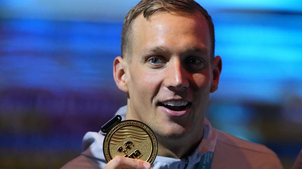 Caeleb Dressel of the United States poses with his medal after winning the Men 50m Butterfly final at the 19th FINA World Championships in Budapest, Hungary, Sunday, June 19, 2022.