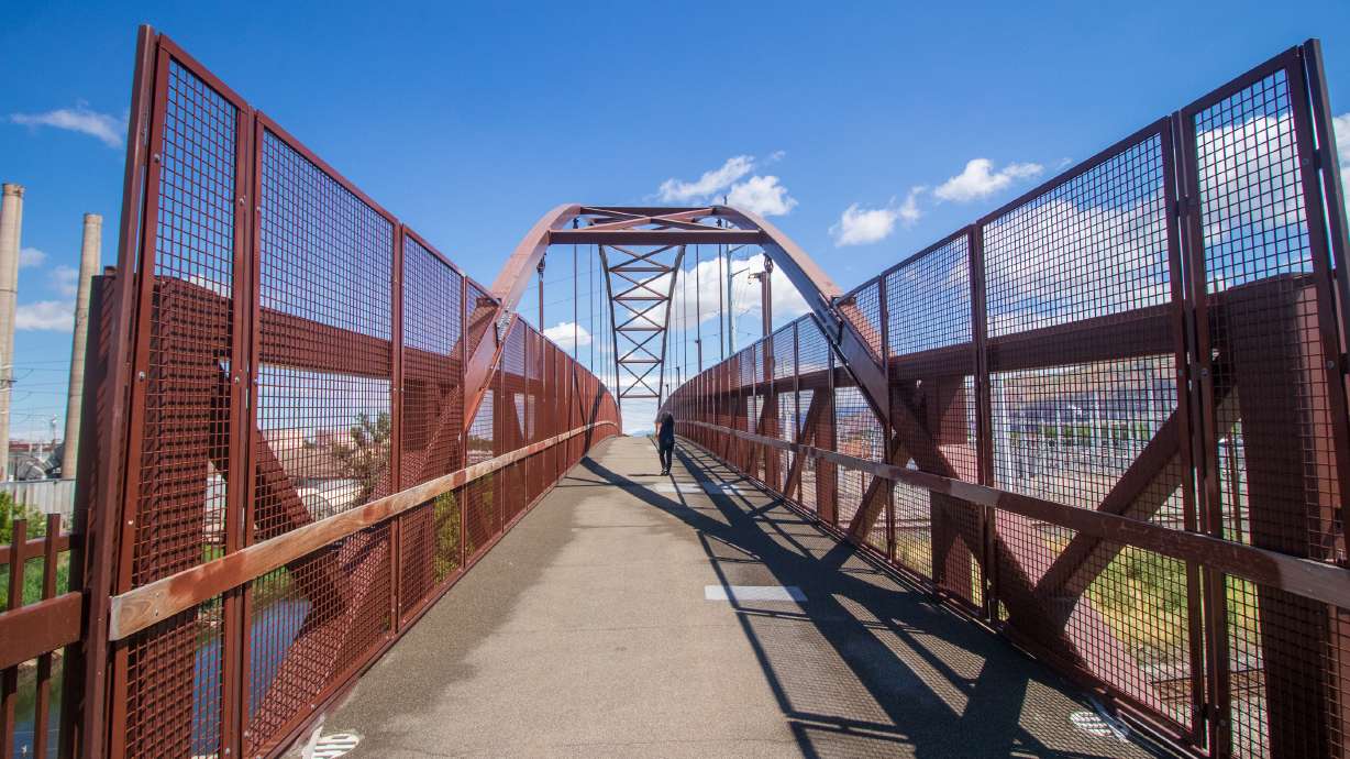 A person walks on the Archie and Lois Archuleta Bridge on Monday. Salt Lake City leaders named the bridge after Archie and Lois Archuleta, a prominent couple for the city's west side, during a ceremony on Friday.
