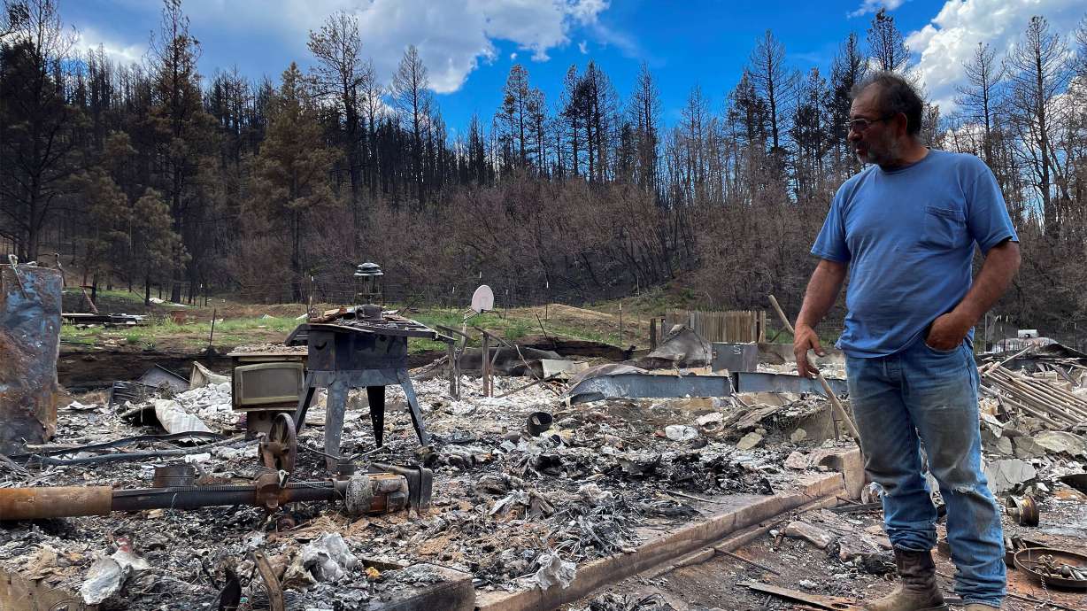 Daniel Encinias stands next to the ruins of his home, which was destroyed by the Hermits Peak/Calf Canyon fire in Tierra Monte, New Mexico.
