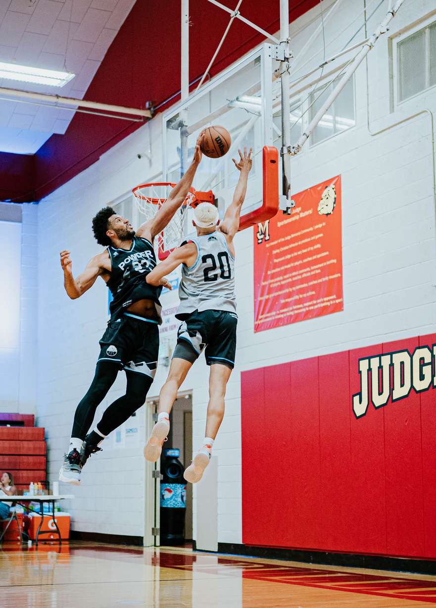 BYU alum Yoeli Childs blocking a shot during a Powder League game at Judge Memorial High School.
