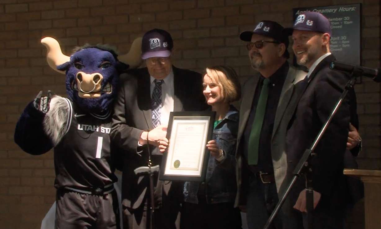 Cache County Executive David Zook, right, poses for a photo with past and present Utah State University staff and USU mascot Big Blue outside of the Aggie Creamery after delivering a proclamation Tuesday that names Aggie Ice Cream the official ice cream of Cache County.