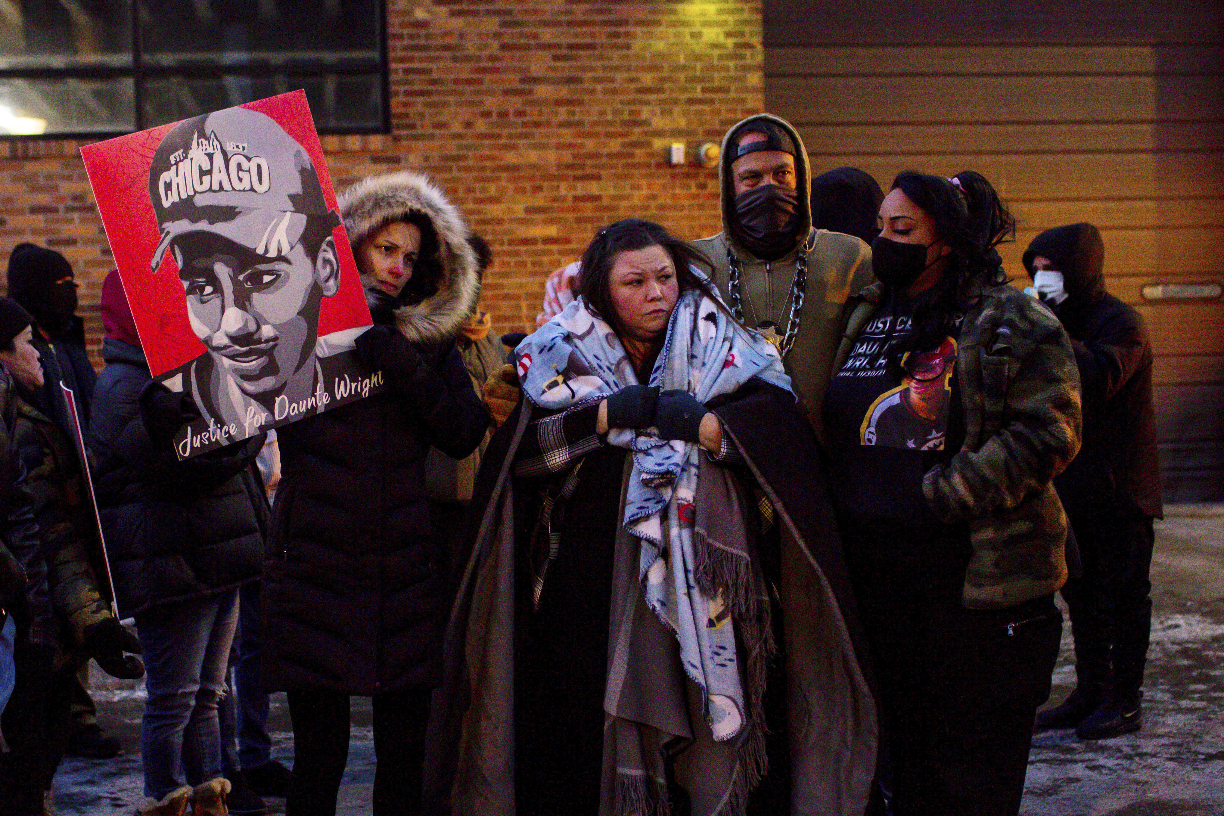 Katie Bryant, Daunte Wright's mother, is surrounded by community members and activists at the apartment building where activists say Hennepin County Judge Regina Chu lives after former officer Kim Potter was sentenced to two years in prison Feb. 18, in Minneapolis. The suburban Minneapolis city has agreed to pay $3.2 million to the family of Daunte Wright, a Black man who was fatally shot by a police officer who said she confused her gun for her Taser. 