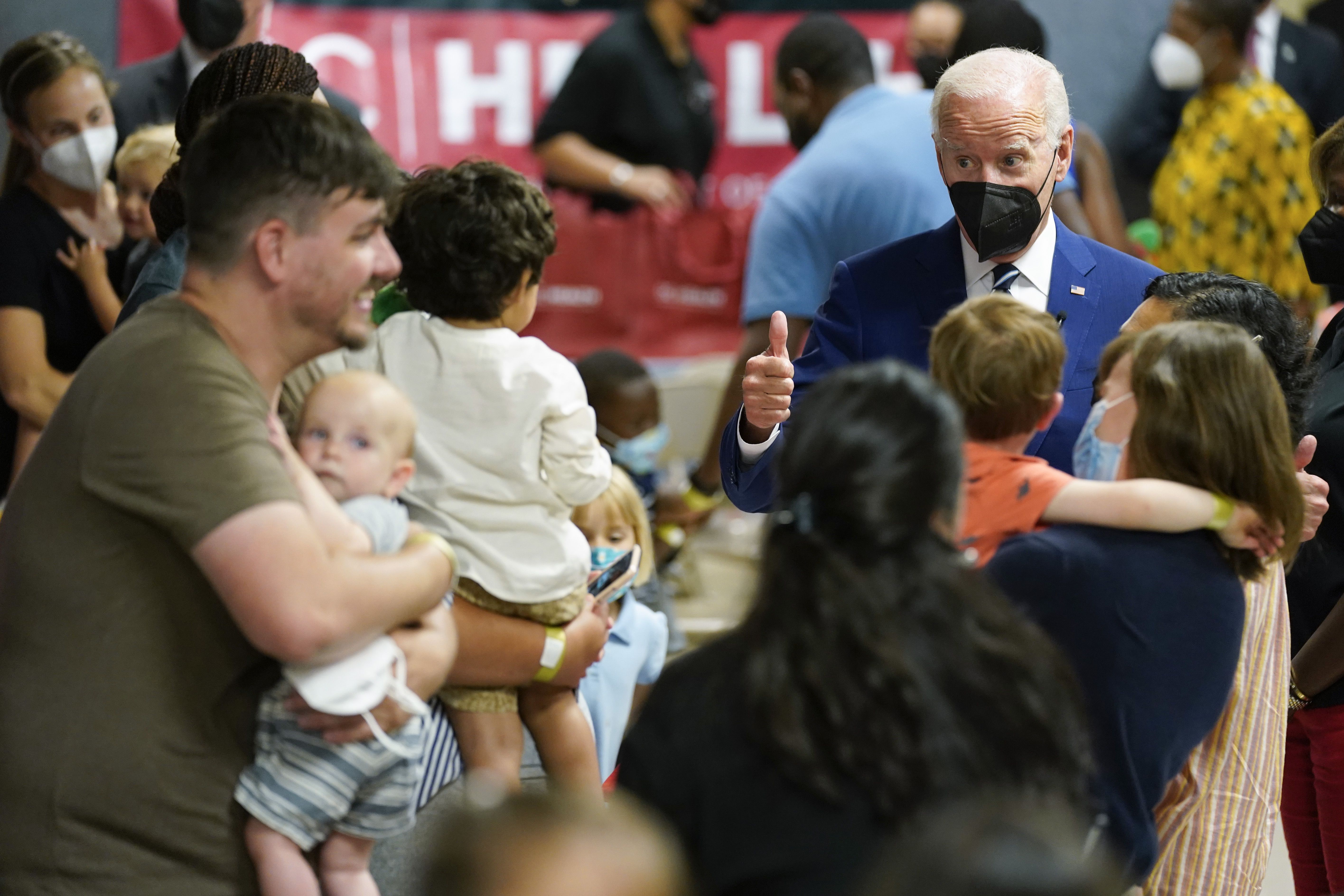 President Joe Biden visits a COVID-19 vaccination clinic at the Church of the Holy Communion on Tuesday, in Washington. Now that children as young as 6 months old can be vaccinated against COVID-19 in the United States, Biden has a warning for politicians.