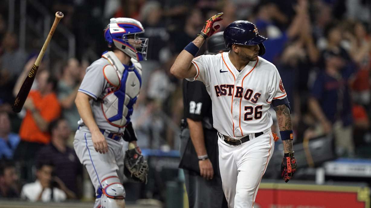 Houston Astros' Jose Siri (26) flips his bat after hitting a home run as New York Mets catcher Patrick Mazeika watches during the eighth inning of a baseball game Tuesday, June 21, 2022, in Houston.