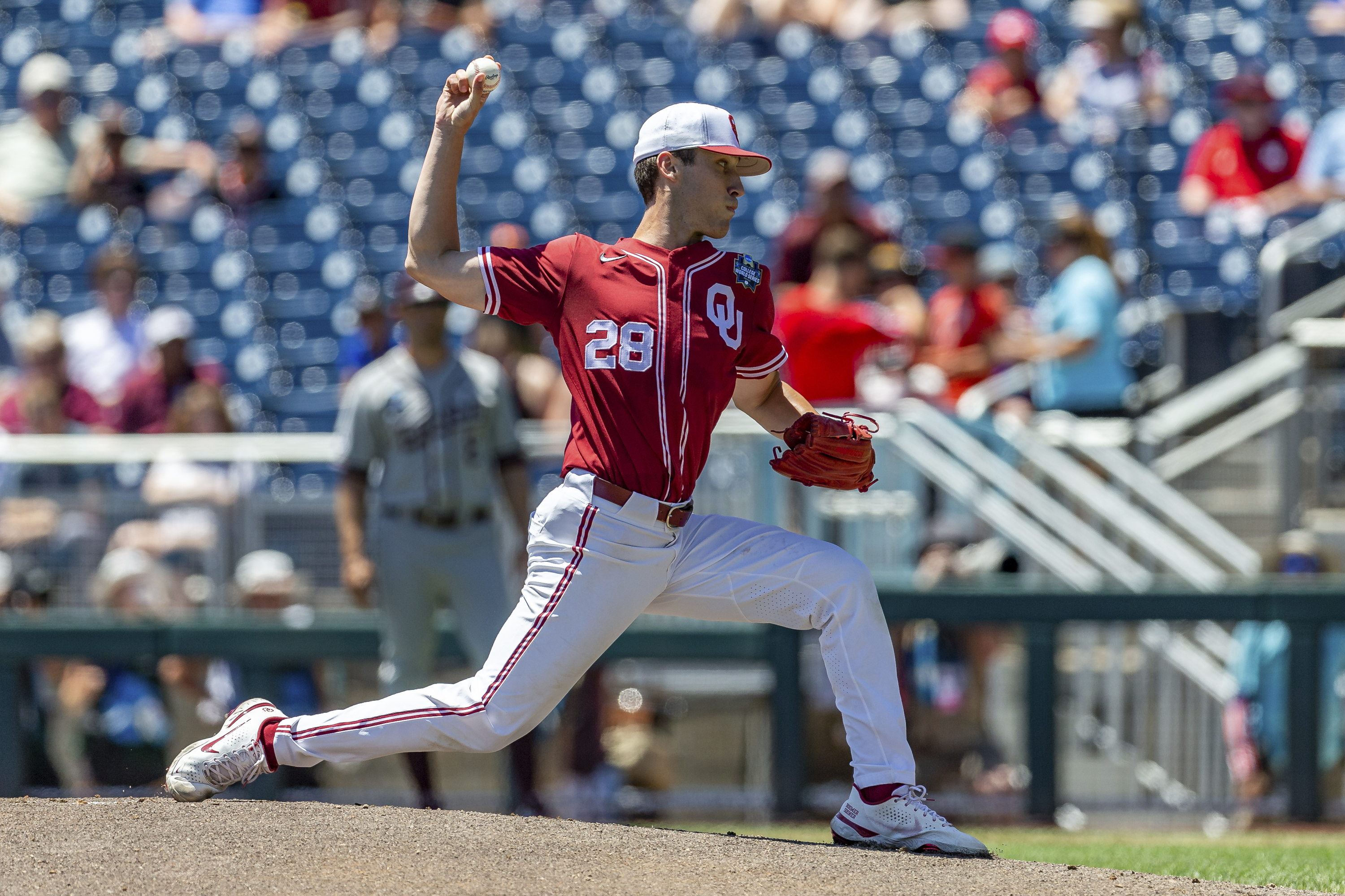 Oklahoma starting pitcher David Sandlin (28) throws a pitch against Texas A&M in the first inning during an NCAA College World Series baseball game Wednesday, June 22, 2022, in Omaha, Neb. 