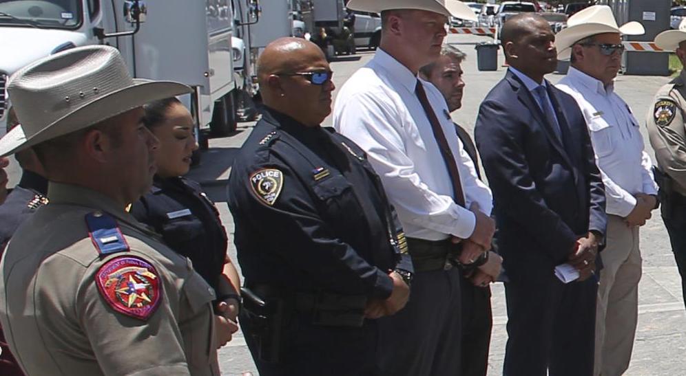 Uvalde School Police Chief Pete Arredondo, third from left, stands during a news conference outside of the Robb Elementary school in Uvalde, Texas, on May 26. Arredondo has been put on leave following allegations that he erred in his response to a mass shooting that left 19 students and two teachers dead.