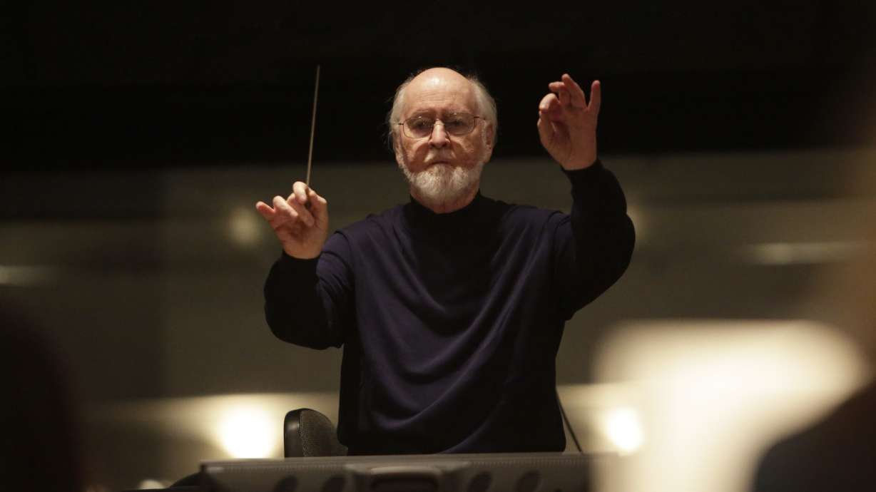 This 2017 photo released by Lucasfilm Ltd. shows John Williams, a five-time Oscar-winning composer. Williams, 90, is devoting himself to composing concert music, including a piano concerto he’s writing for Emanuel X. This spring, he and cellist Yo-Yo Ma released the album “A Gathering of Friends,” recorded with the New York Philharmonic.