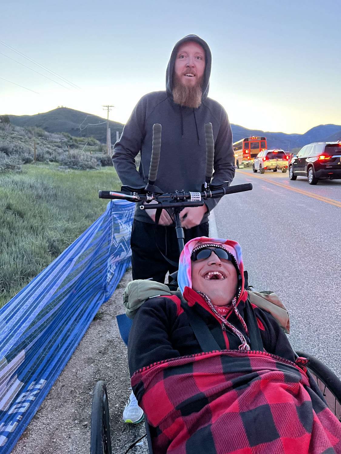 Zach Talley pushes Reese Thorne during a race.