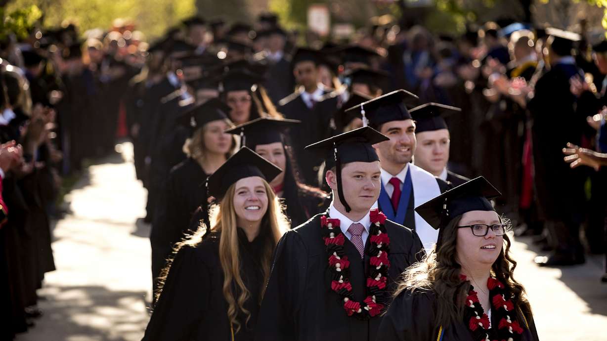Graduating students walk in the processional to the 123rd annual commencement for Southern Utah University in Cedar City on April 19. As the Biden administration ponders student loan forgiveness, Dartmouth College will eliminate student loans from financial aid packages for undergraduate students, extending more grants instead.