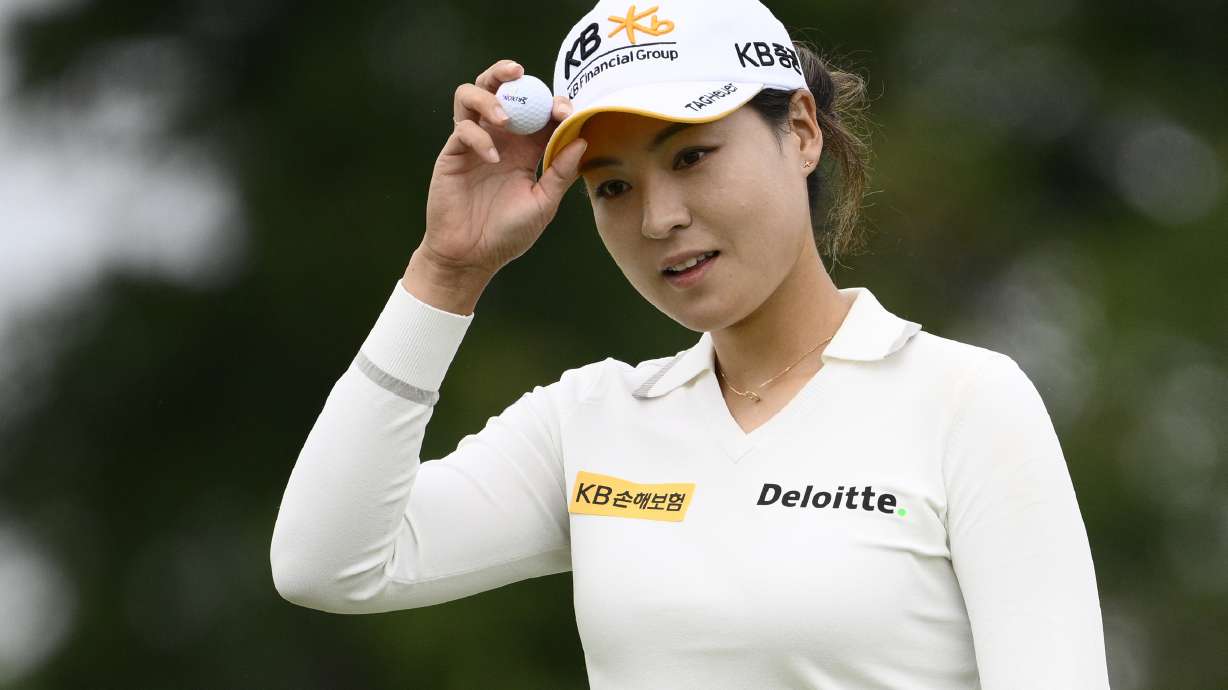 In Gee Chun, of South Korea, holds her ball after finishing her round on the ninth hole during the first round in the Women's PGA Championship golf tournament at Congressional Country Club, Thursday, June 23, 2022, in Bethesda, Md.