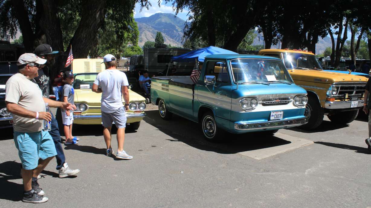 Car fans walk past vintage Corvairs at the 2021 Cache Valley Cruise-In in Logan. You can win two cars at the annual Cruise-In's custom car giveaway this weekend, but you'll have to wait three weeks to legally do burnouts in them.