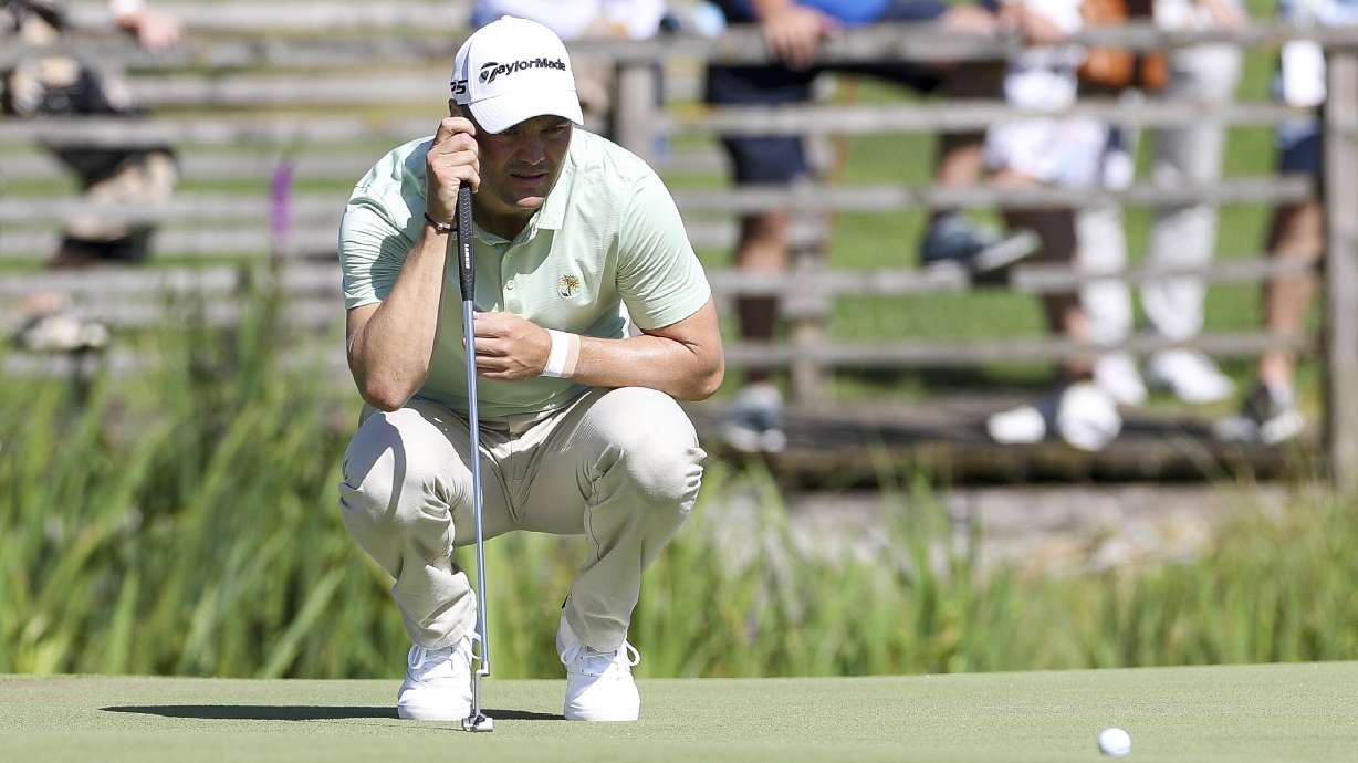 Germany's Martin Kaymer squats on the green during the German International Open golf tournament at Golfclub Muenchen Eichenried in Munich, Germany, Thursday, June 23, 2022.