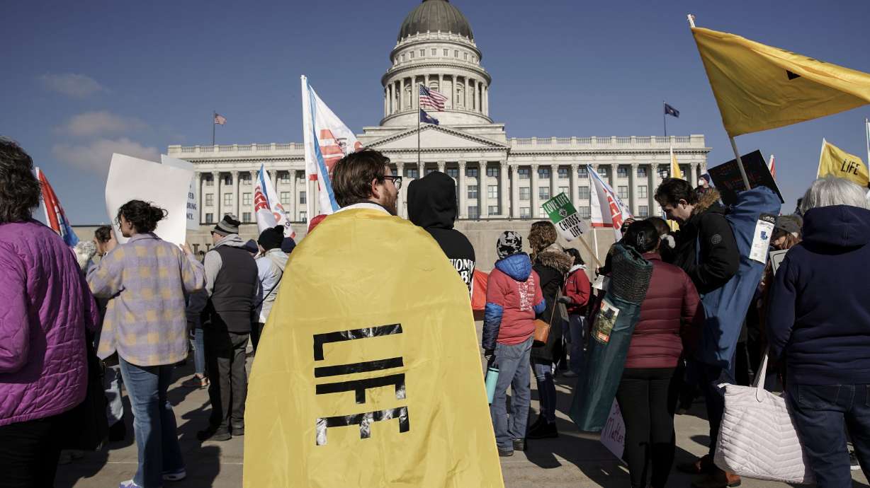 A rallygoer with a “life” flag is pictured before a March for Life rally in Salt Lake City on Jan. 22. The U.S. Supreme Court overturned Roe v. Wade on Friday, revoking the constitutional right to an abortion that has been in place for nearly 50 years.