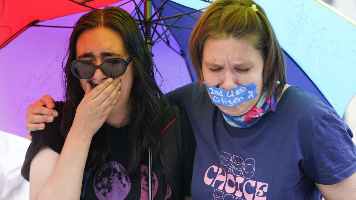 Abortion-rights activists react after hearing the Supreme Court decision on abortion outside the Supreme Court in Washington, Friday. The Supreme Court has ended constitutional protections for abortion that had been in place nearly 50 years in a decision by its conservative majority to overturn Roe v. Wade.