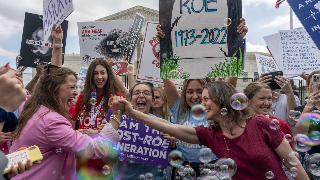 Anti-abortion protesters celebrate following Supreme Court’s decision to overturn Roe v. Wade, federally protected right to abortion, outside the Supreme Court in Washington on Friday. The Supreme Court has ended constitutional protections for abortion that had been in place for nearly 50 years, a decision by its conservative majority to overturn the court’s landmark abortion cases.