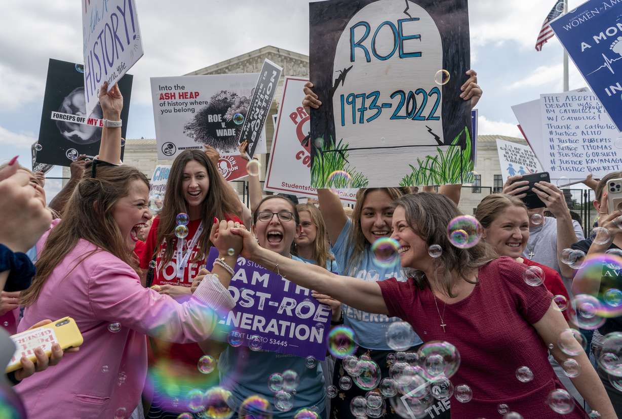 Anti-abortion protesters celebrate following Supreme Court’s decision to overturn Roe v. Wade, federally protected right to abortion, outside of the Supreme Court in Washington, Friday. The Supreme Court has ended constitutional protections for abortion that had been in place nearly 50 years, a decision by its conservative majority to overturn the court’s landmark abortion cases.