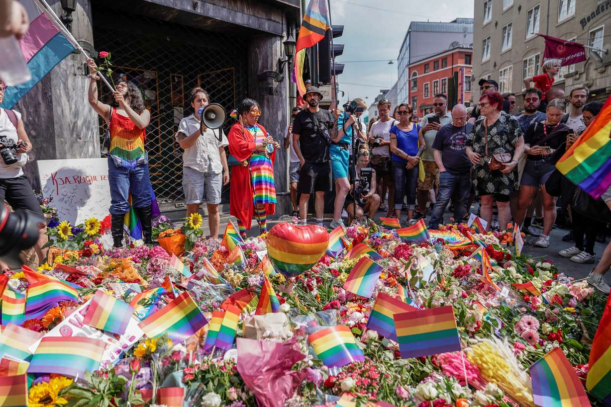 People taking part in a spontaneous Pride parade arrive at the London Pub, a popular gay bar and nightclub, to pay tribute to the victims of the shooting, after the official event was cancelled, in central Oslo, Norway on Saturday.