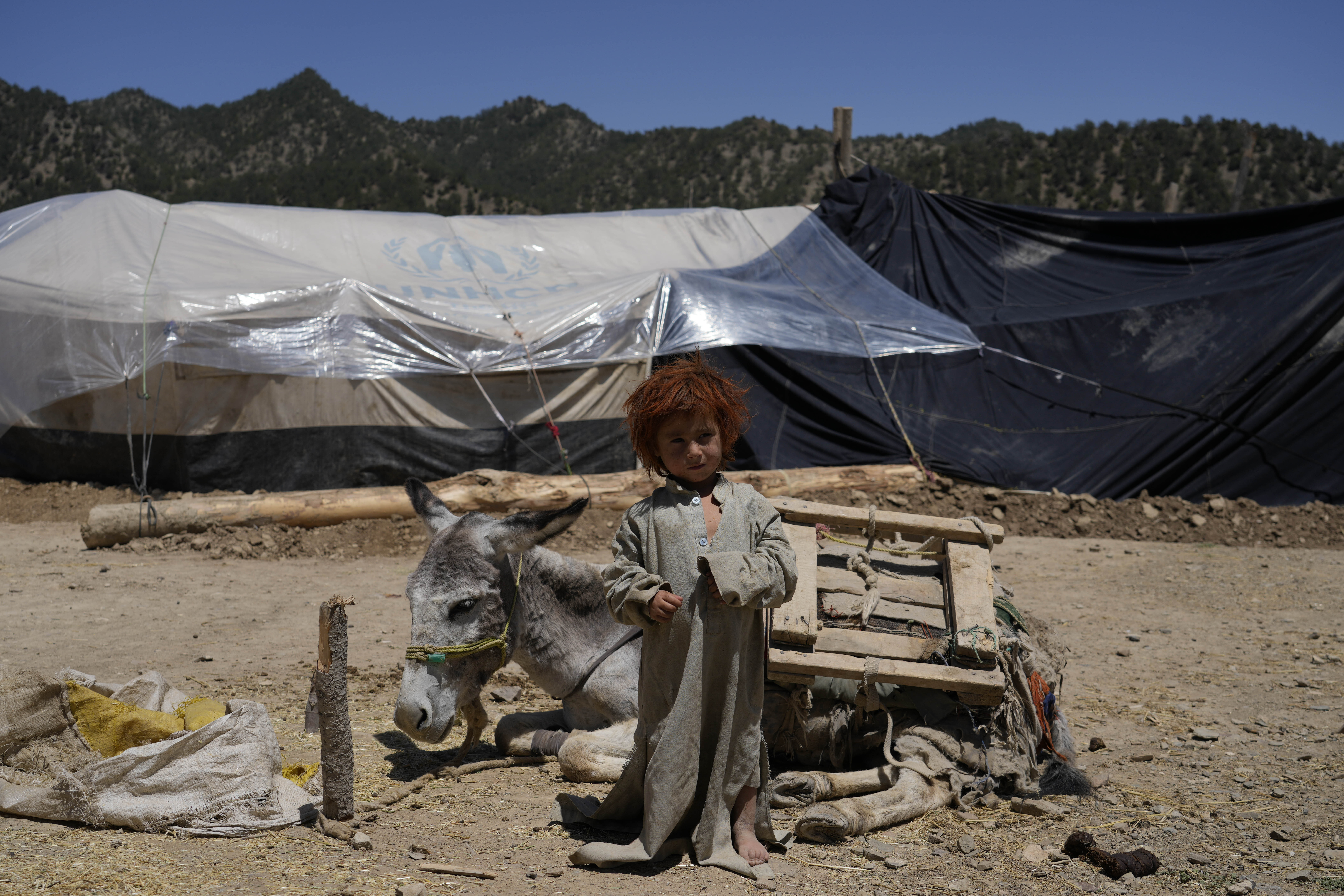 Afghan child stands in front of a makeshift shelter after an earthquake in Gayan village, in Paktika province, Afghanistan, Friday. A powerful earthquake struck a rugged, mountainous region of eastern Afghanistan early Wednesday, flattening stone and mud-brick homes in the country's deadliest quake in two decades, the state-run news agency reported.