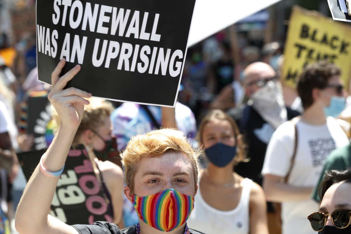 A person holds up a sign referencing the Stonewall Inn, during a queer liberation march for Black Lives Matter and against police brutality, Sunday, June 28, 2020, in New York. Parades celebrating LGBTQ pride kick off in some of America's biggest cities Sunday amid new fears about the potential erosion of freedoms won through decades of activism. The annual marches in New York, San Francisco, Chicago and elsewhere take place just two days after one conservative justice on the Supreme Court signaled, in a ruling on abortion, that the court should reconsider the right to same-sex marriage recognized in 2015.