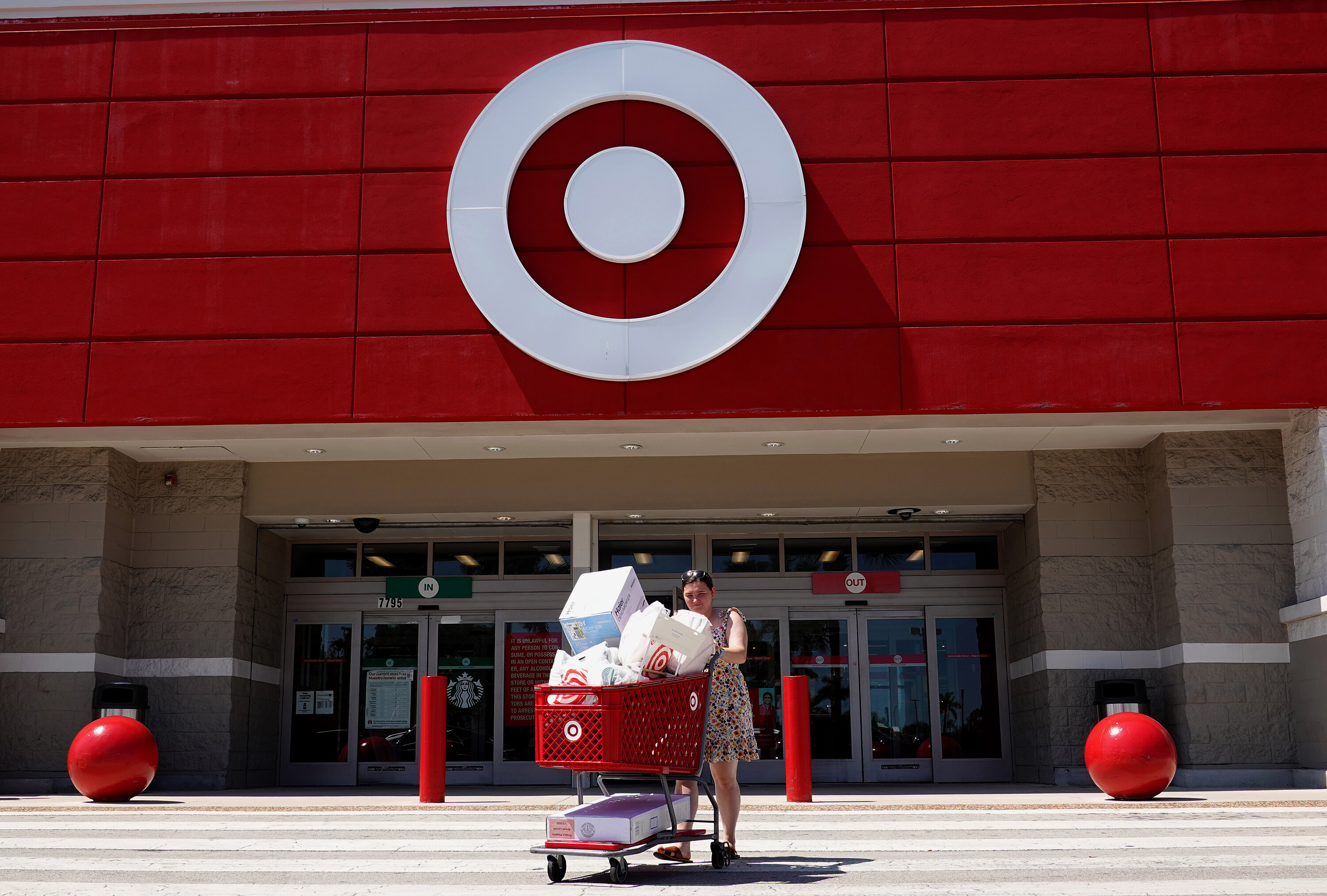 A customer exits from a Target store on May 18, in Miami, Florida. The chaotic mix of record fuel prices and an unending supply chain crisis have retailers considering the unthinkable: Instead of returning your unwanted items, just keep them.
