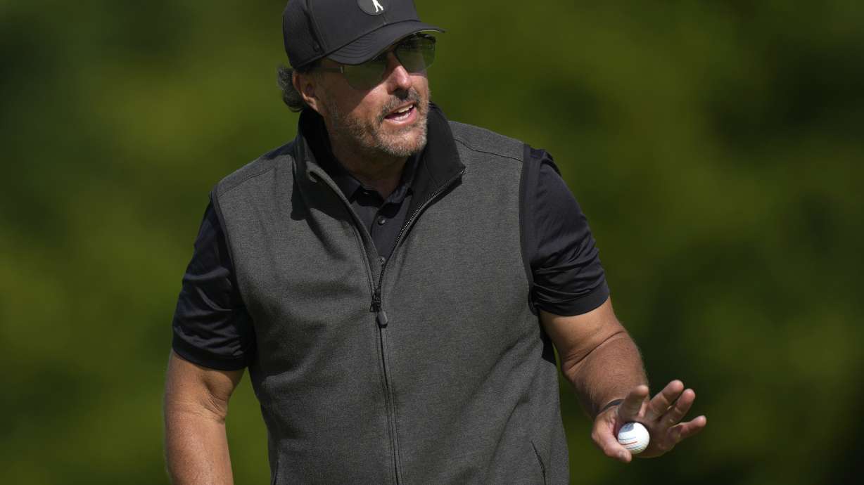 Phil Mickelson of the United States reacts to the crowd after putting on the 15th green during the final round of the inaugural LIV Golf Invitational at the Centurion Club in St Albans, England, Saturday, June 11, 2022.