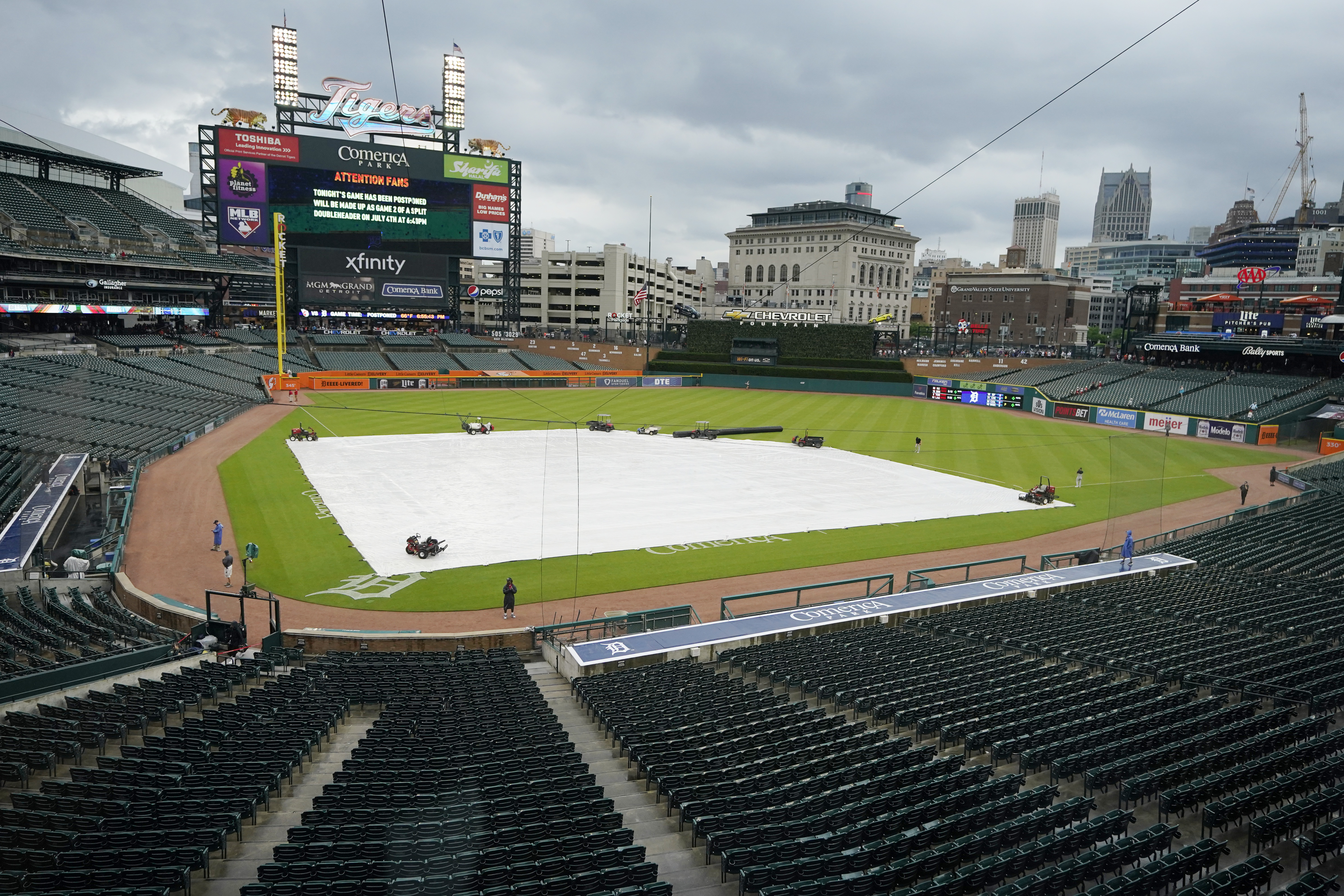 The Comerica Park infield is covered prior to the baseball game between the Detroit Tigers and the Cleveland Guardians was postponed because of rain, Friday, May 27, 2022, in Detroit. 